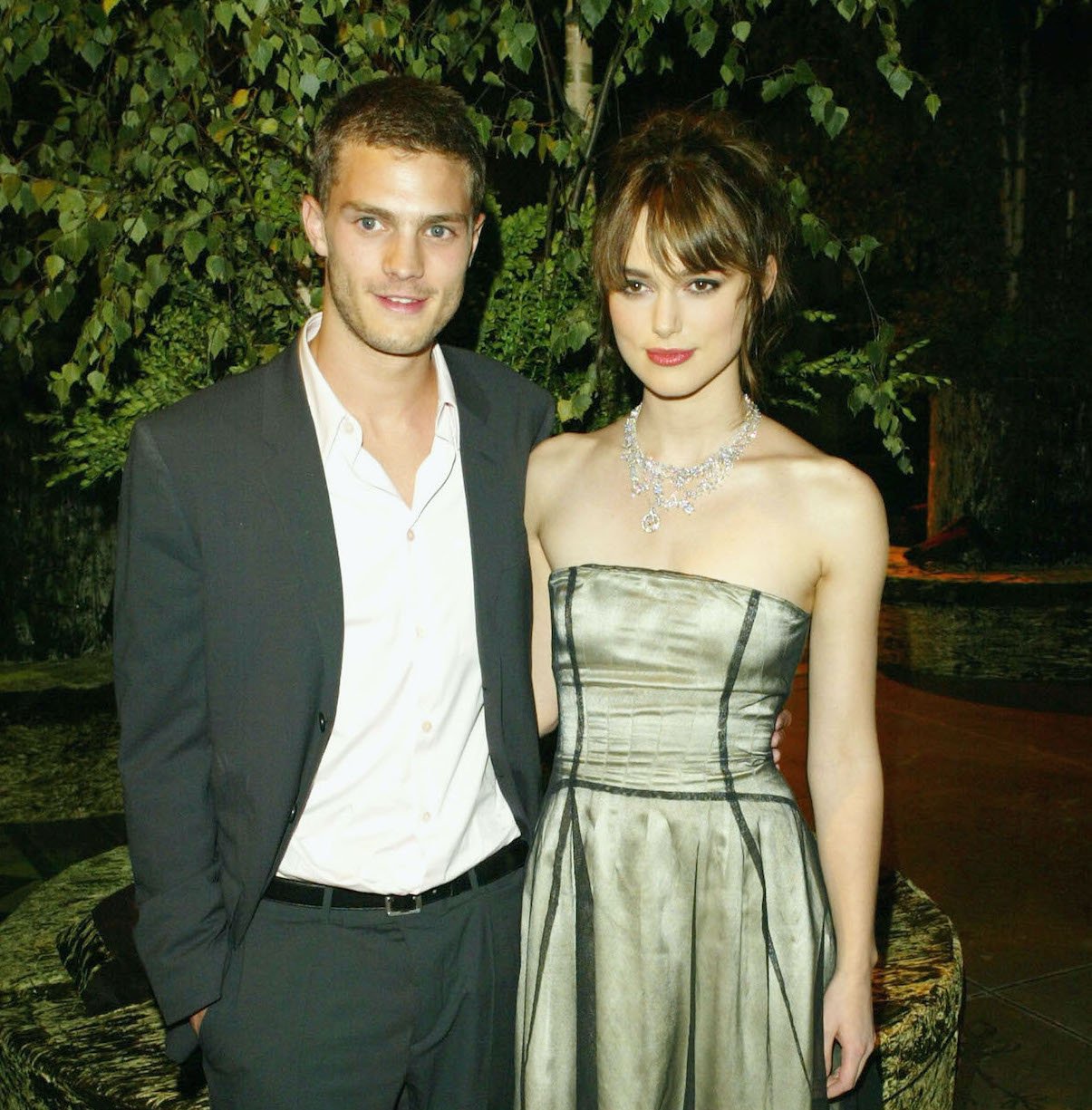 Jamie Dornan and Keira Knightley in front of a tree