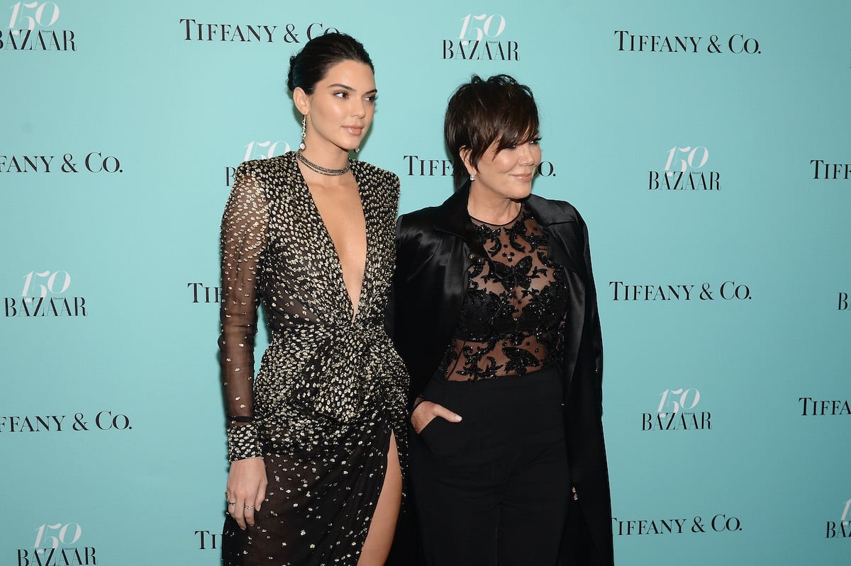 Kendall Jenner and Kris Jenner pose together at a red carpet event