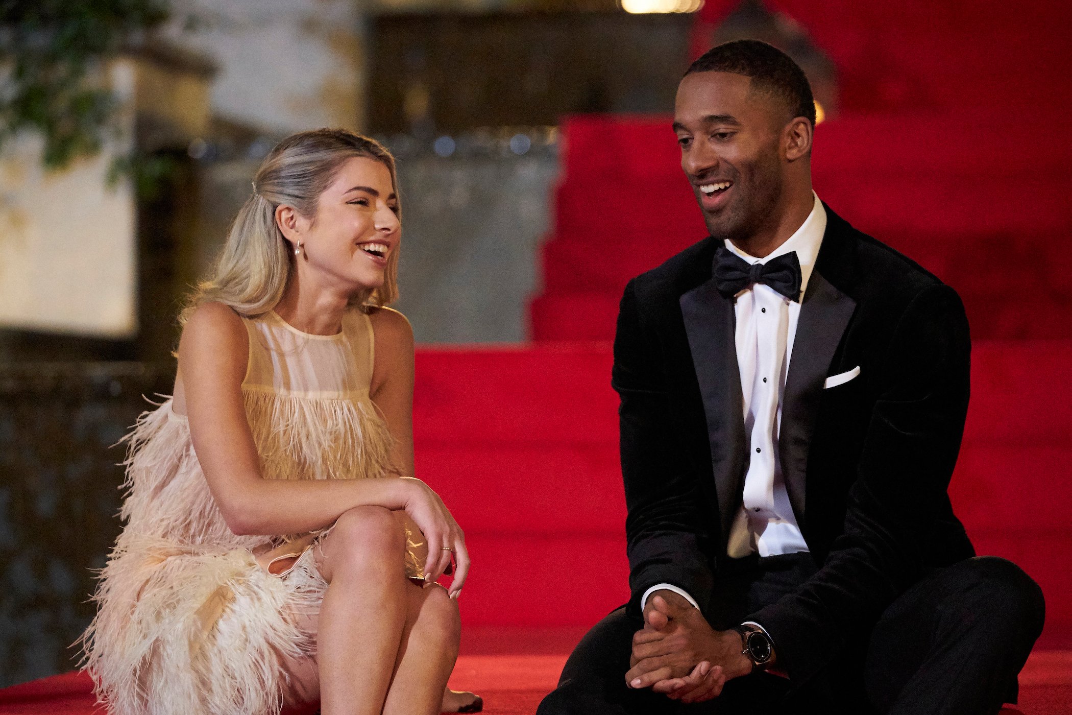 Kit Keenan and Matt James dressed in fancy clothing sitting next to each other on the first night of 'The Bachelor'