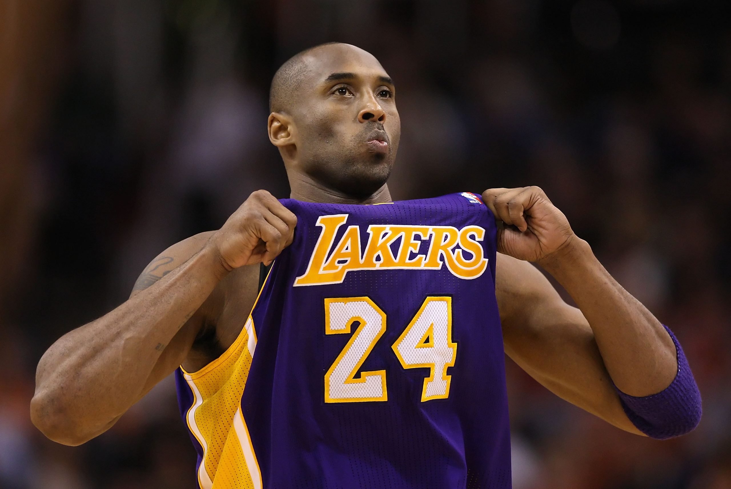 Kobe Bryant holds up his Lakers jersey for the crowd crowd at US Airways Center on February 19, 2012.