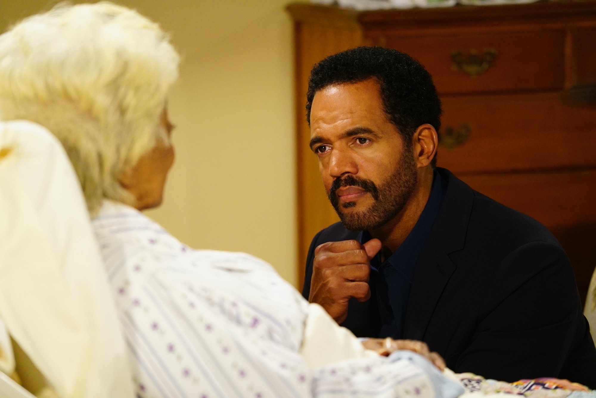Kristoff St. John sitting at a hospital bedside on 'The Young and the Restless'