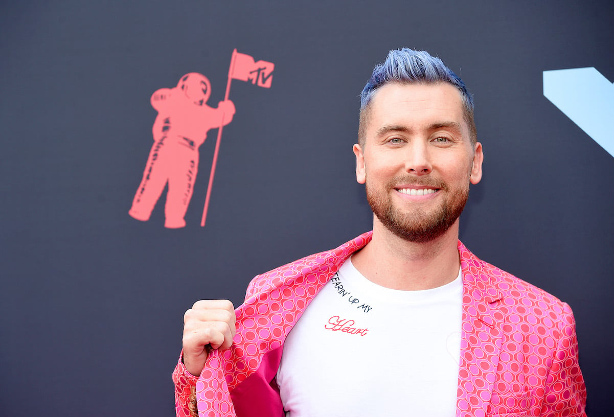 Lance Bass in a pink suit and blue hair