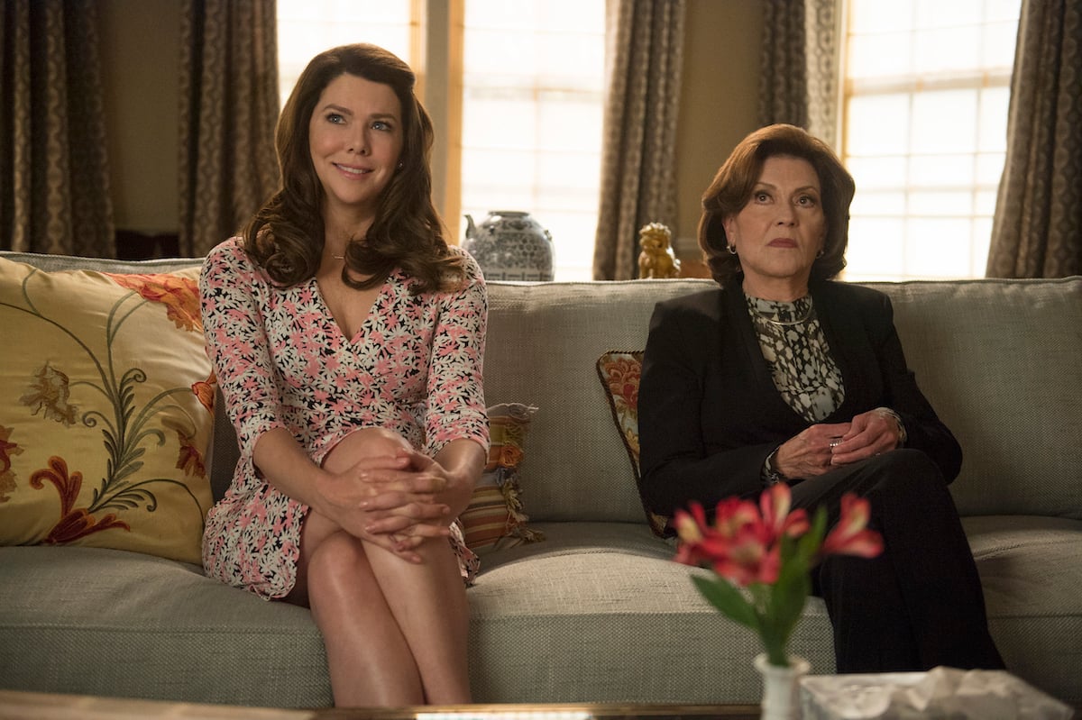 Lauren Graham as Lorelai Gilmore and Kelly Bishop as Emily Gilmore sit next to each other on a couch during a scene from 'Gilmore Girls: A Year in the Life.'