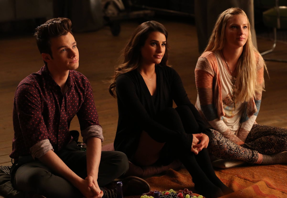 Chris Colfer, Lea Michele, and Heather Morris in character sitting down on 'Glee' set