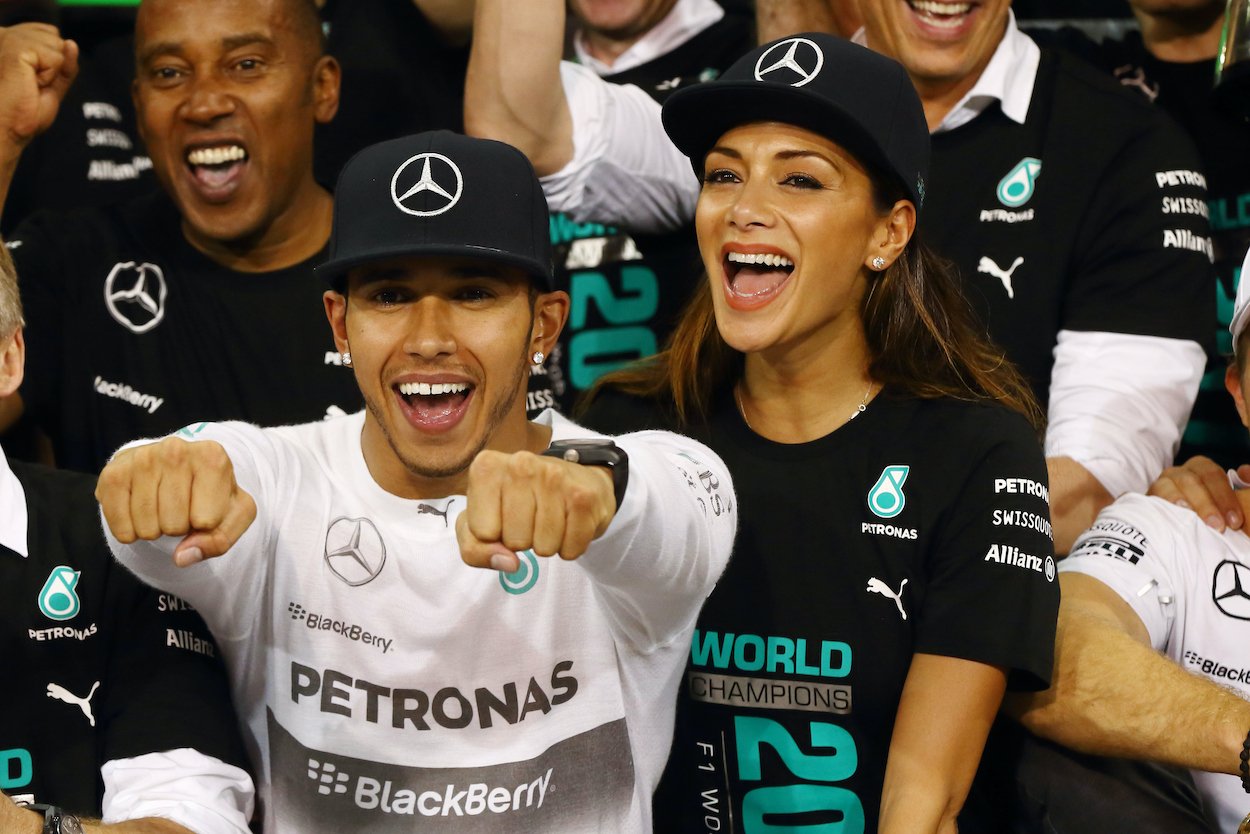 F1 driver Lewis Hamilton smiles for the camera with his now-ex-girlfriend