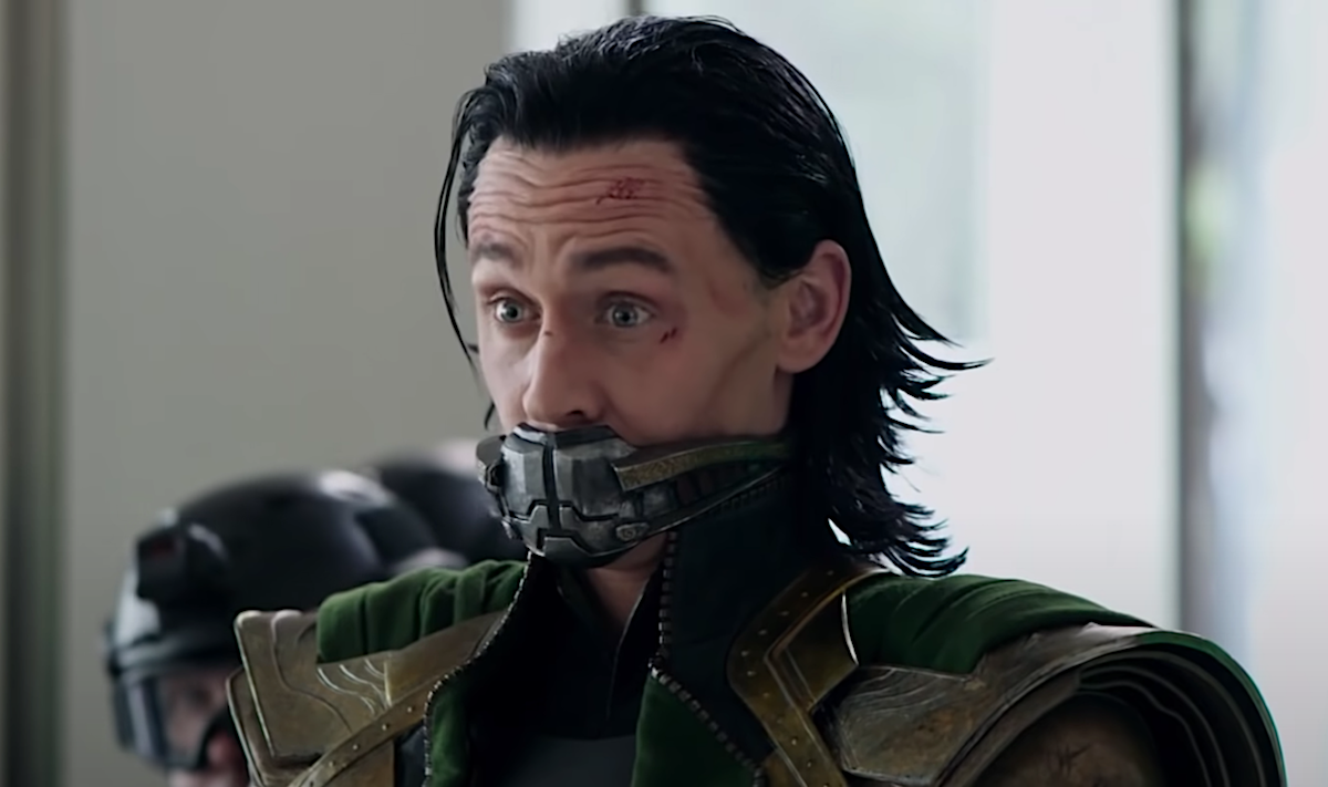 Tom Hiddleston with a metal mask over his mouth and his face cut up as Loki in 'Avengers: Endgame.'