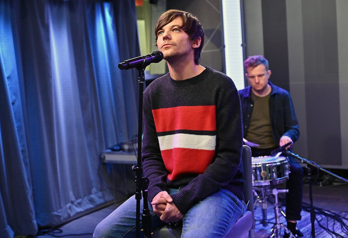 Louis Tomlinson performing in a sweater