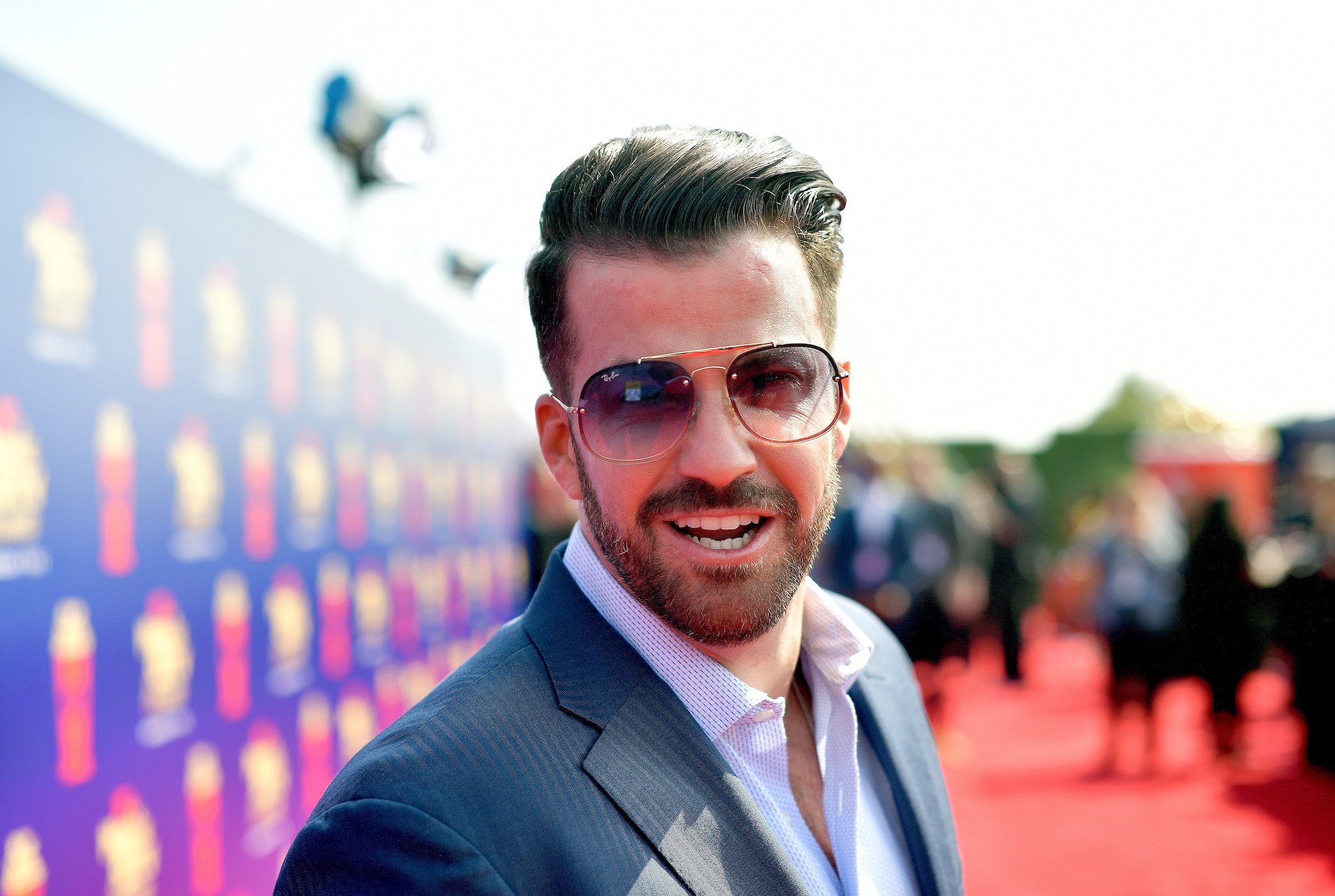 Johnny 'Bananas' Devenanzio from MTV's 'The Challenge' wearing a suit and sunglasses looking into the camera at the 2019 MTV Movie and TV Awards