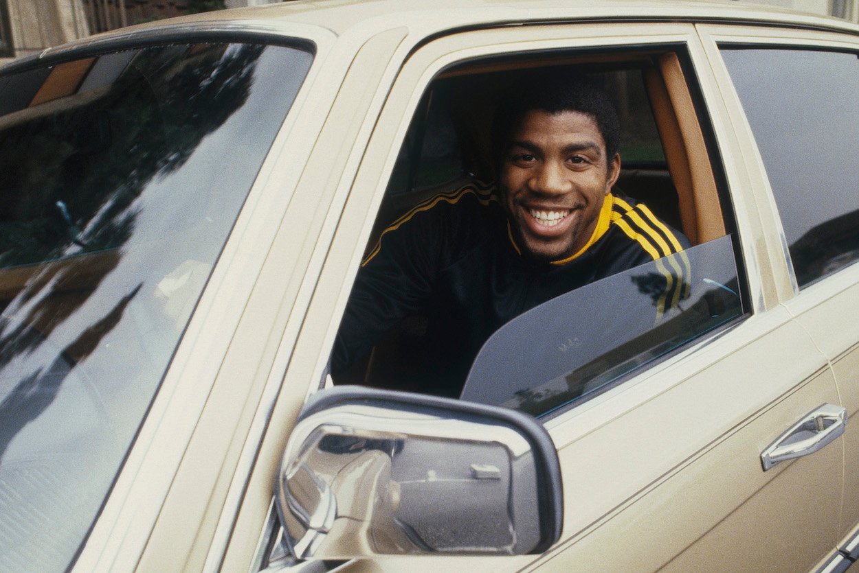 Los Angeles Lakers' center Magic Johnson smiles in his car