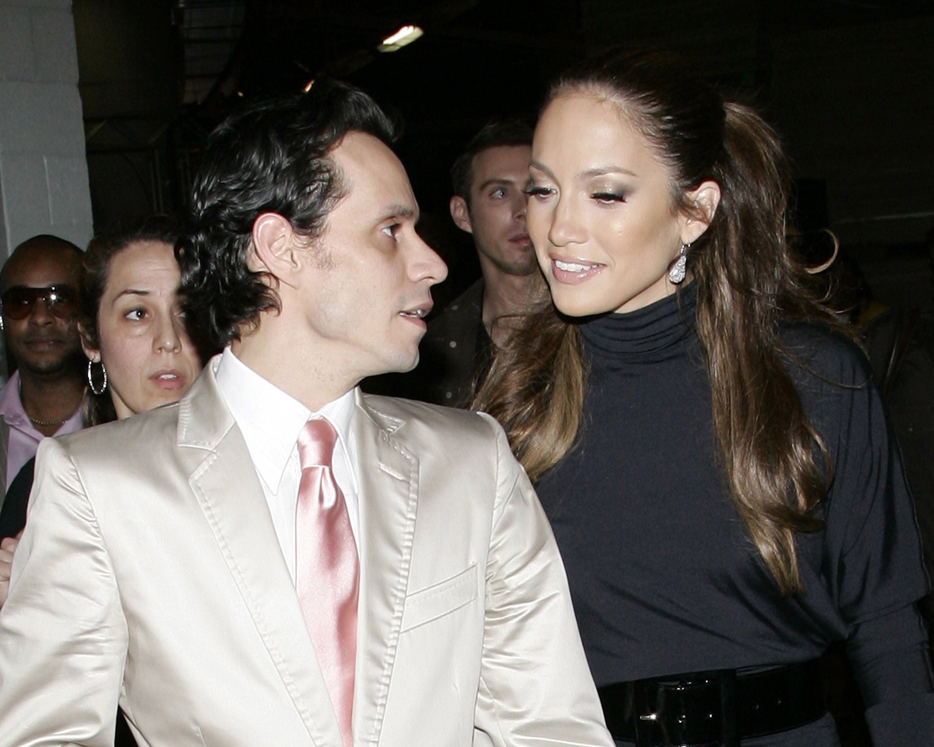 Marc Anthony speaking to Jennifer Lopez while attending a red carpet event.