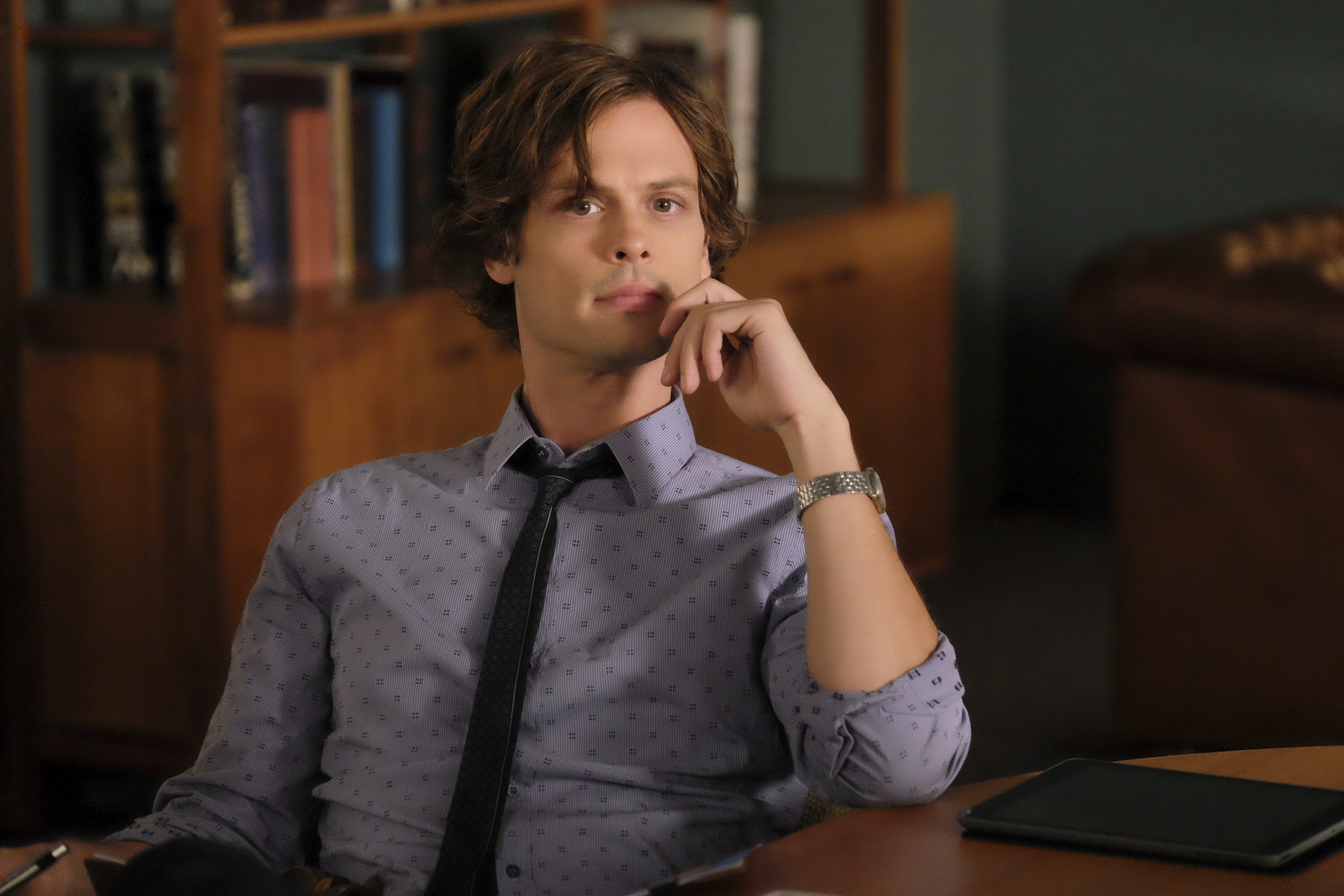 Matthew Gray Gubler on 'Criminal Minds' sitting at a table