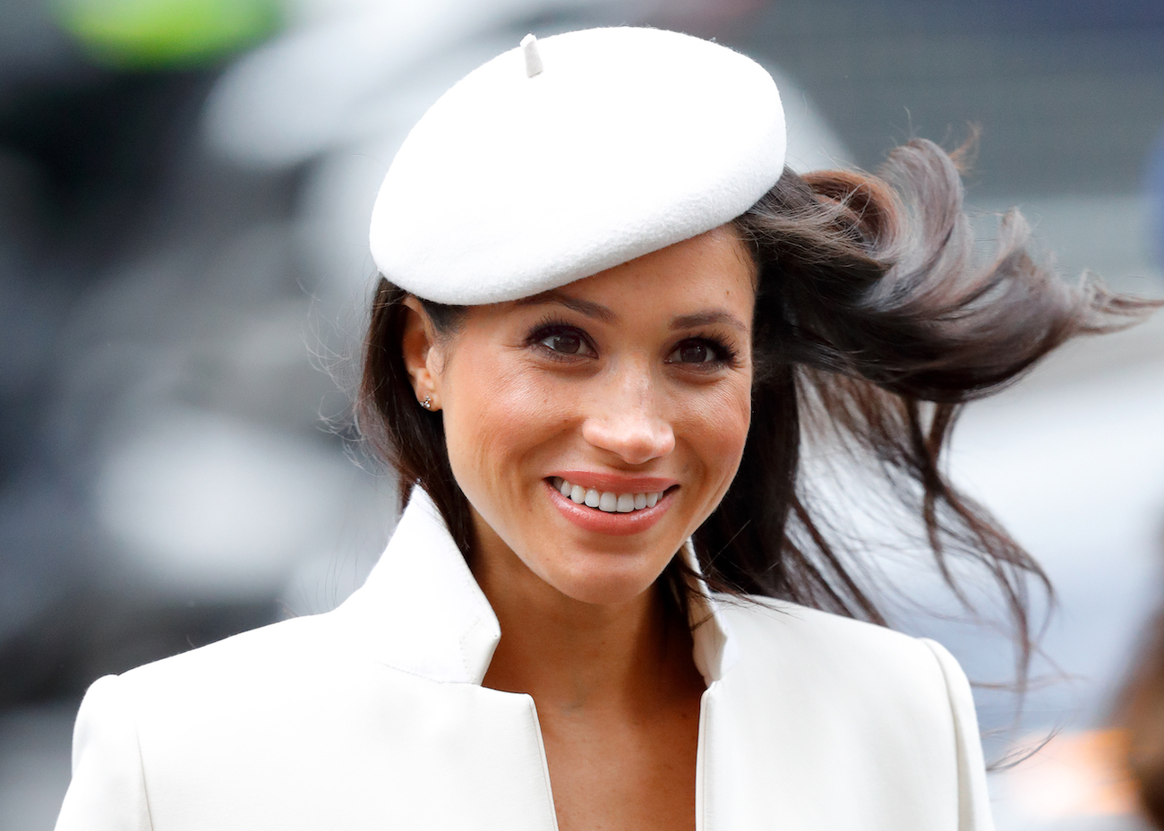 Meghan Markle wearing white, smiling