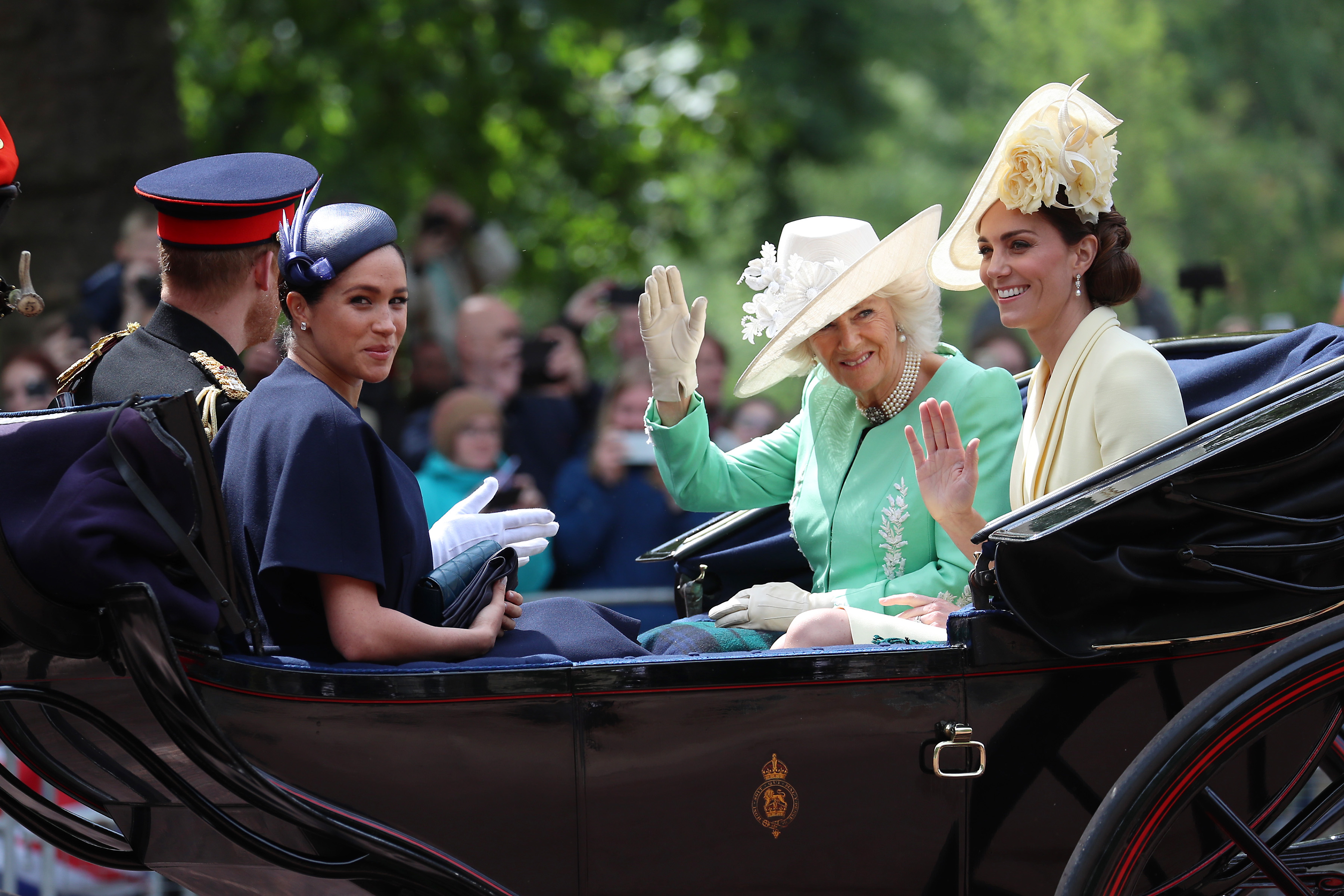 Meghan Markle, Camilla Parker Bowles, and Kate Middleton riding in a carriage during Trooping The Colour 2019