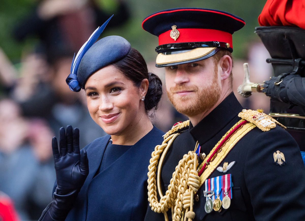 Prince Harry, Duke of Sussex and Meghan, Duchess of Sussex ride by carriage down the Mall during Trooping The Colour,