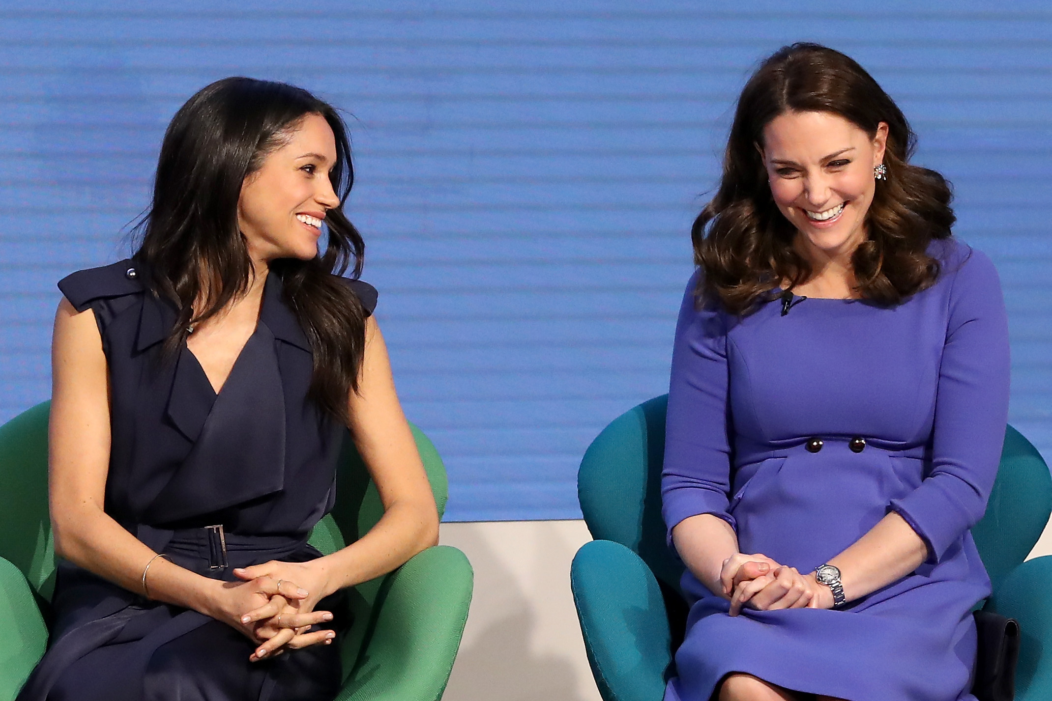 Meghan Markle and Kate Middleton seated on stage next to each other at the Royal Foundation Forum in 2018