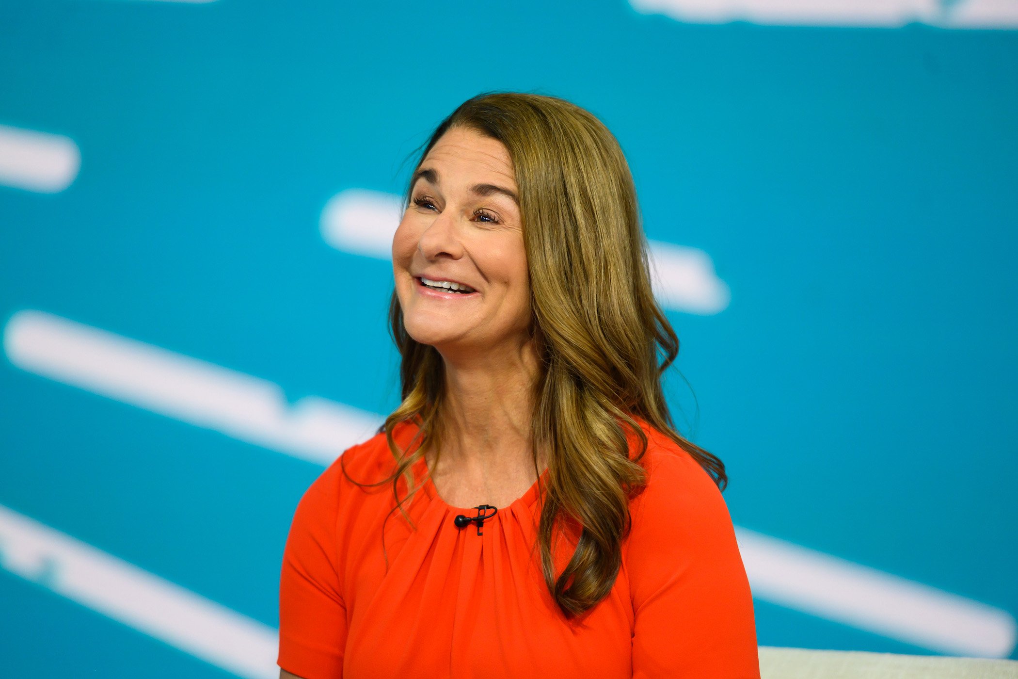 Melinda Gates, Bill Gates' wife, smiling against a blue background