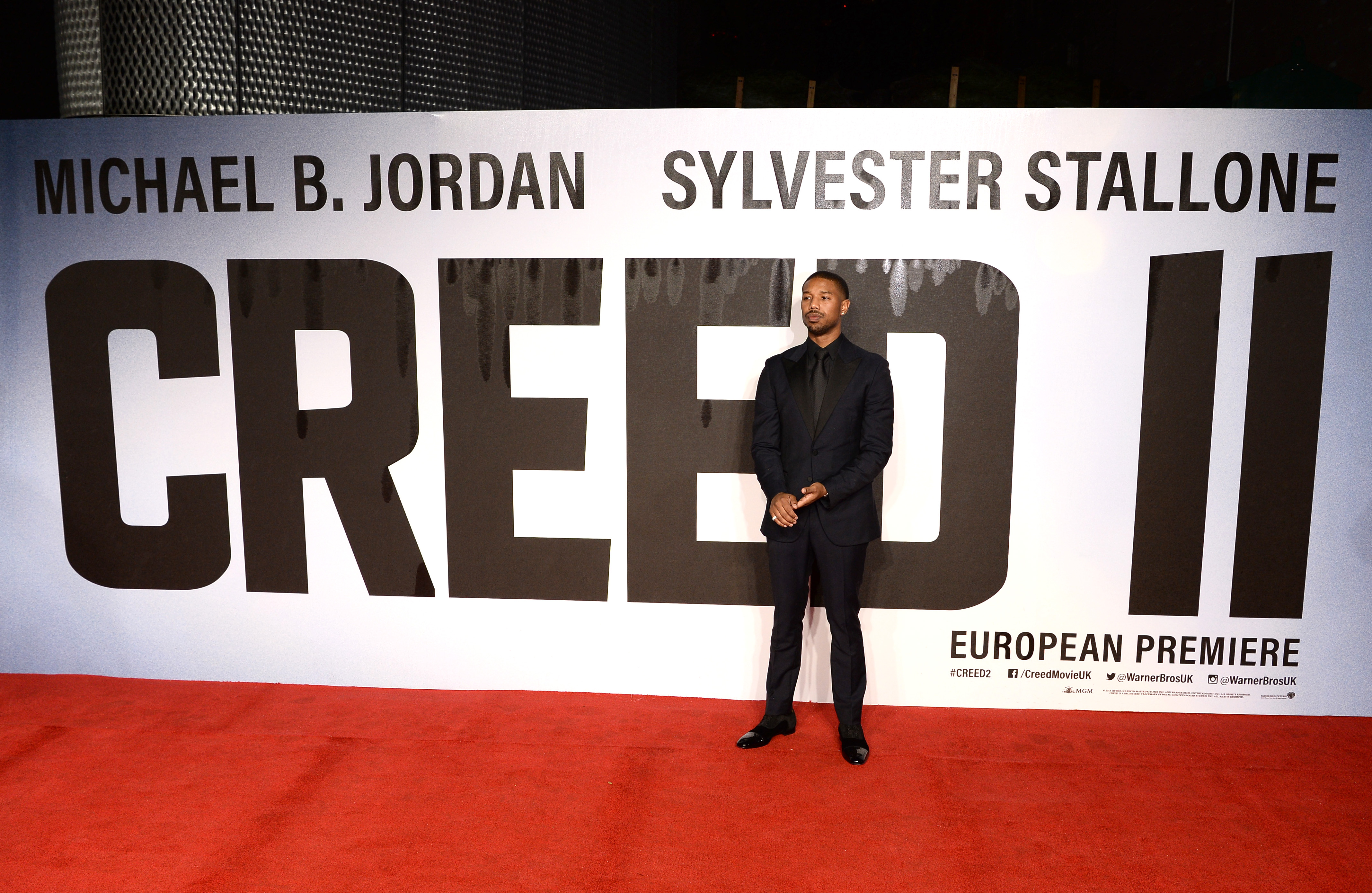 Michael B. Jordan stands on the red carpet at the Creed II premiere