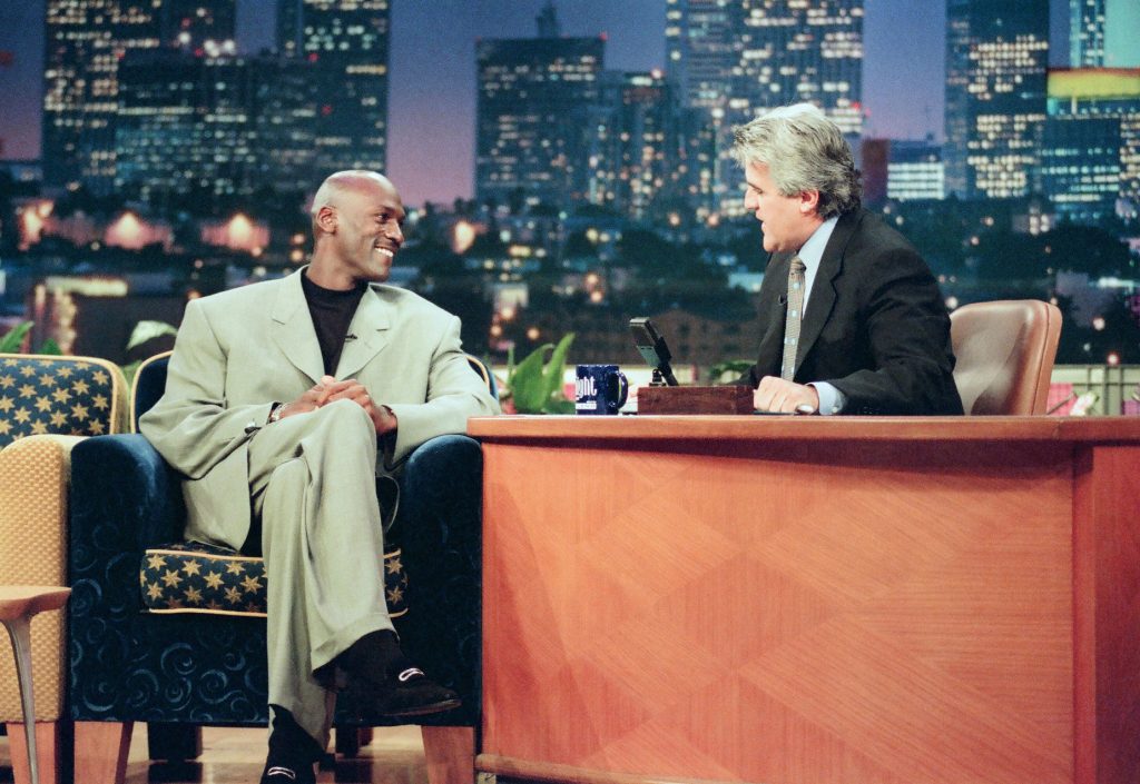 Michael Jordan wears one of his signature baggy suits while being interviewed by Jay Leno.