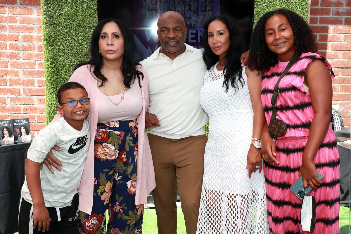 Mike Tyson (C) poses with(L-R) his son Morocco, mother-in-law Rita Ali, wife Lakiha Spicer, and daughter Milan Tyson at the 100 Women Matter Luncheon