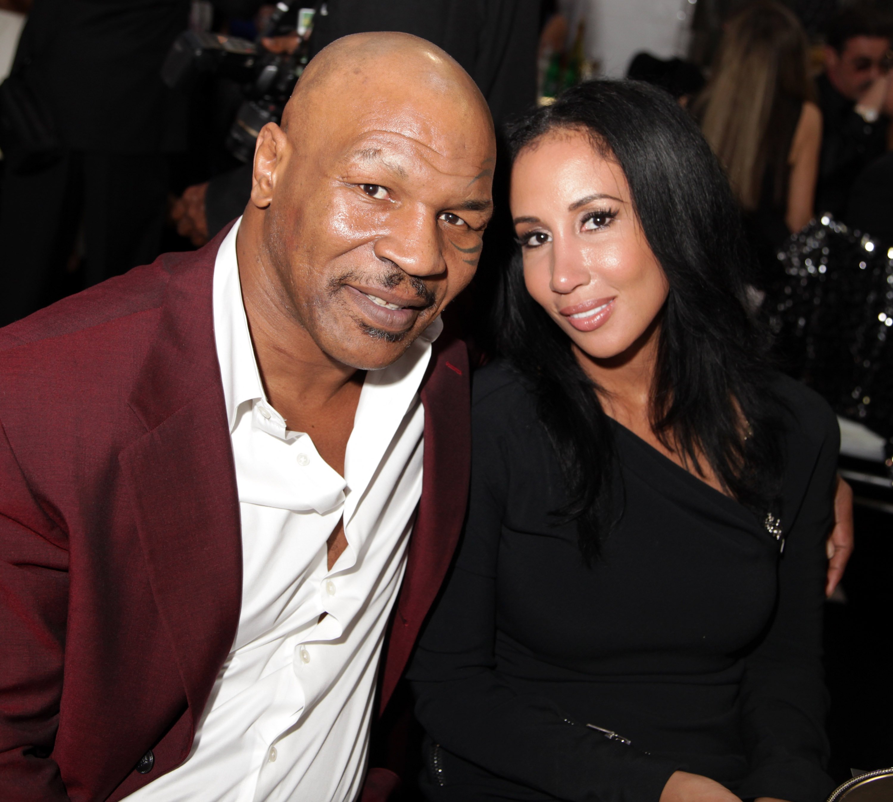 Mike Tyson and his wife Lakiha 'Kiki' Spicer seated next to each other and posing for a photo at Academy Awards Viewing Party Benefiting Children Uniting Nations