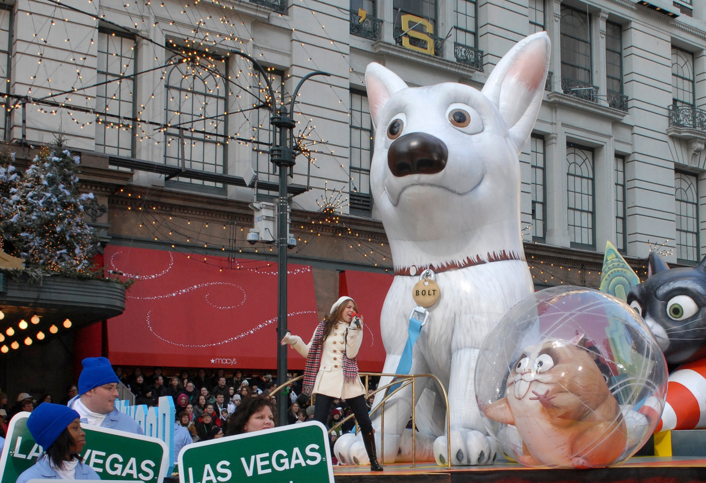 Miley Cyrus performs on a 'Bolt' themed float