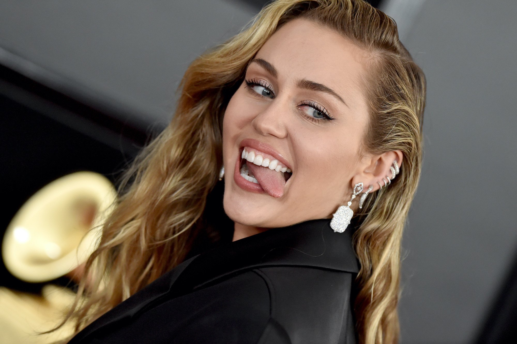 Miley Cyrus sticking out her tongue, turned to the camera