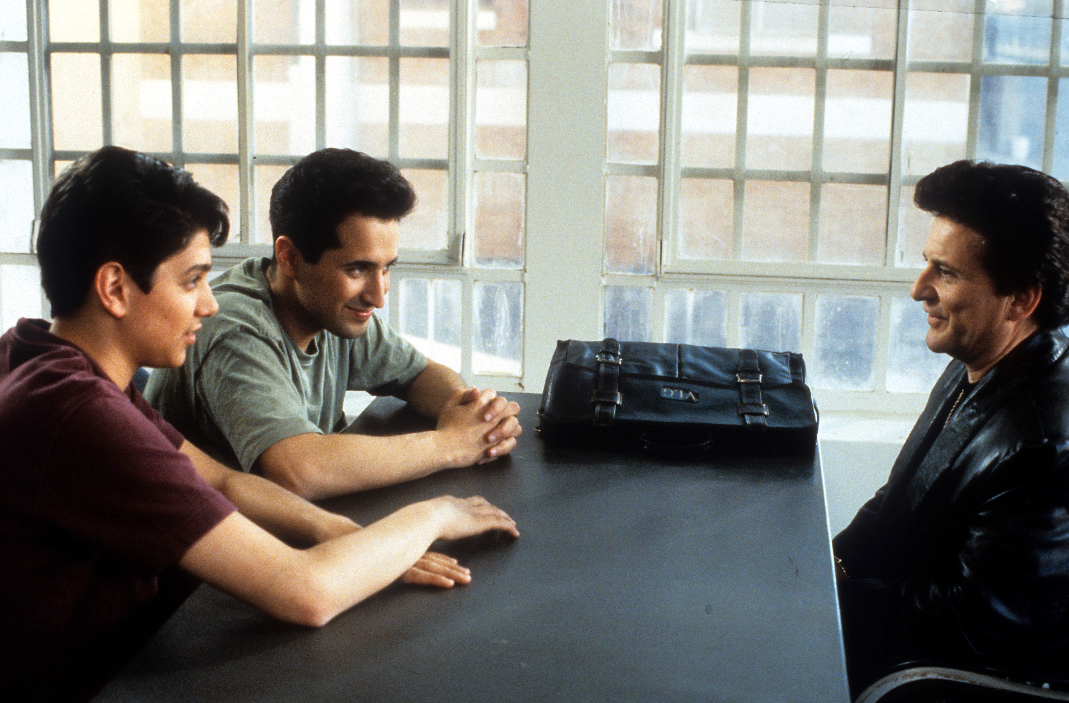 Ralph Machio as Bill Gambini and Mitchell Whitfield as Stan Rothenstein sit in front of Joe Pesci as Vinny Gambini in 'My Cousin Vinny'