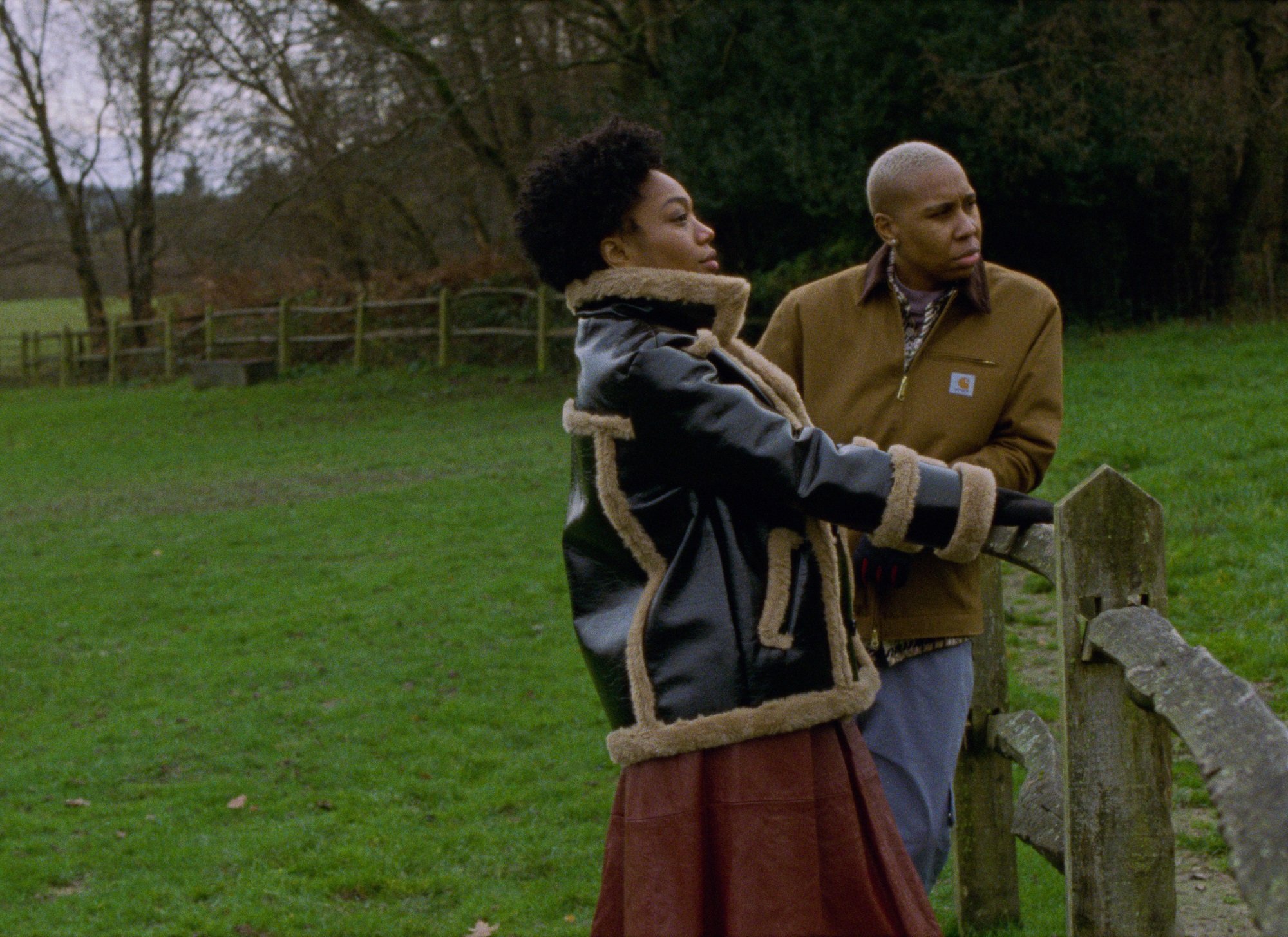 Naomi Ackie and Lena Waithe lean on a fence