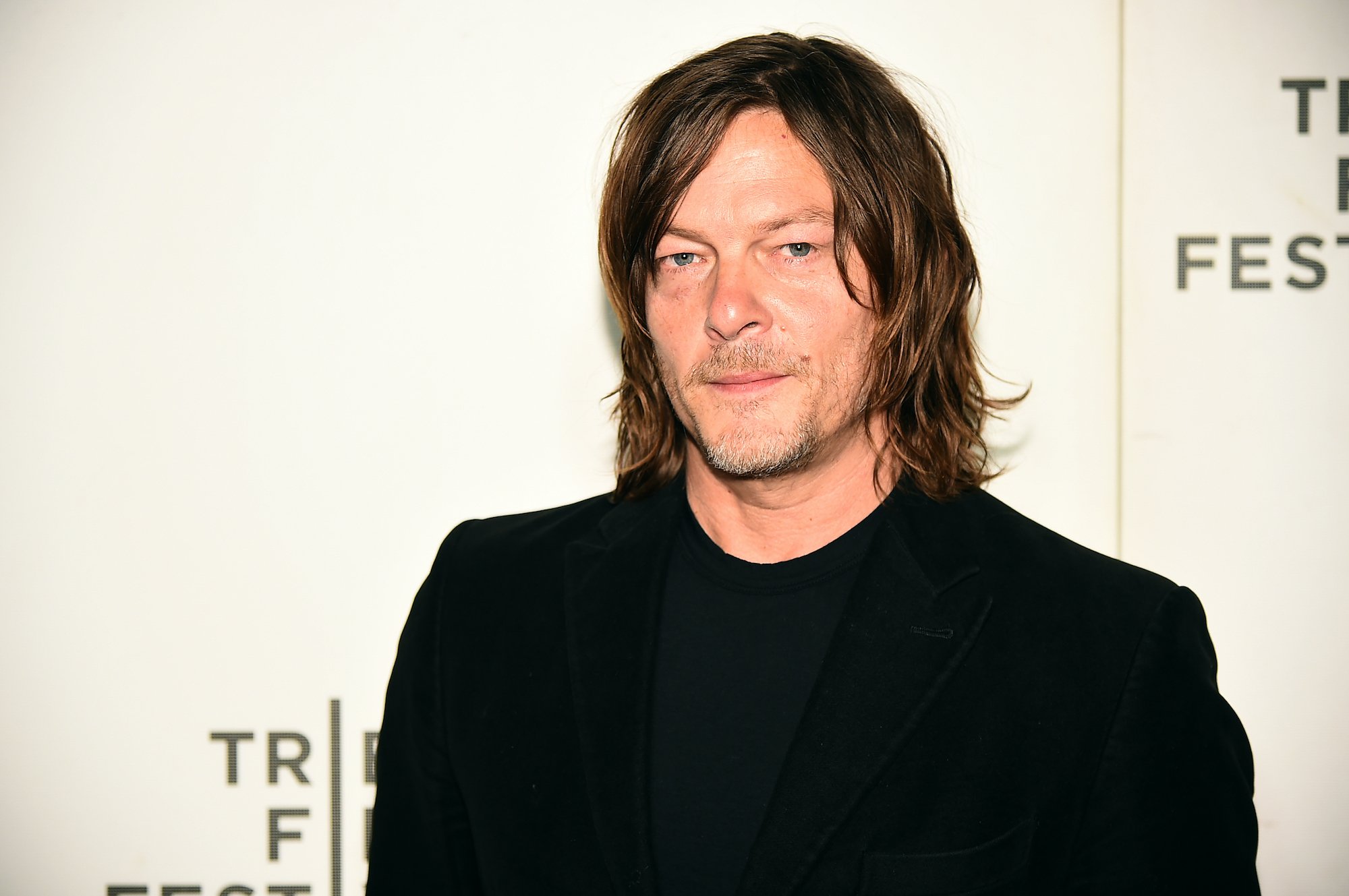 Norman Reedus in front of a white background