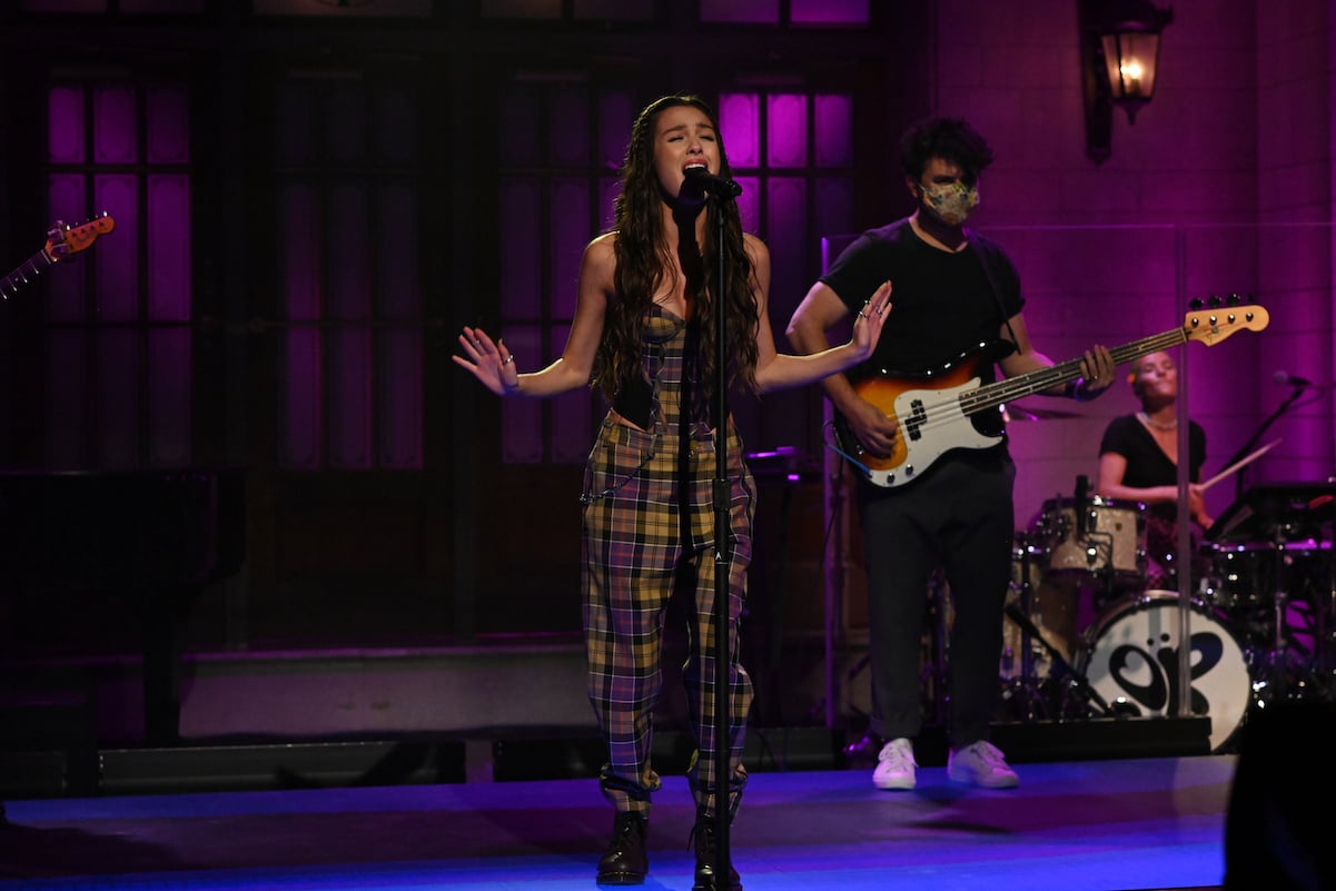 Olivia Rodrigo in a plaid jumpsuit performing on 'Saturday Night Live'