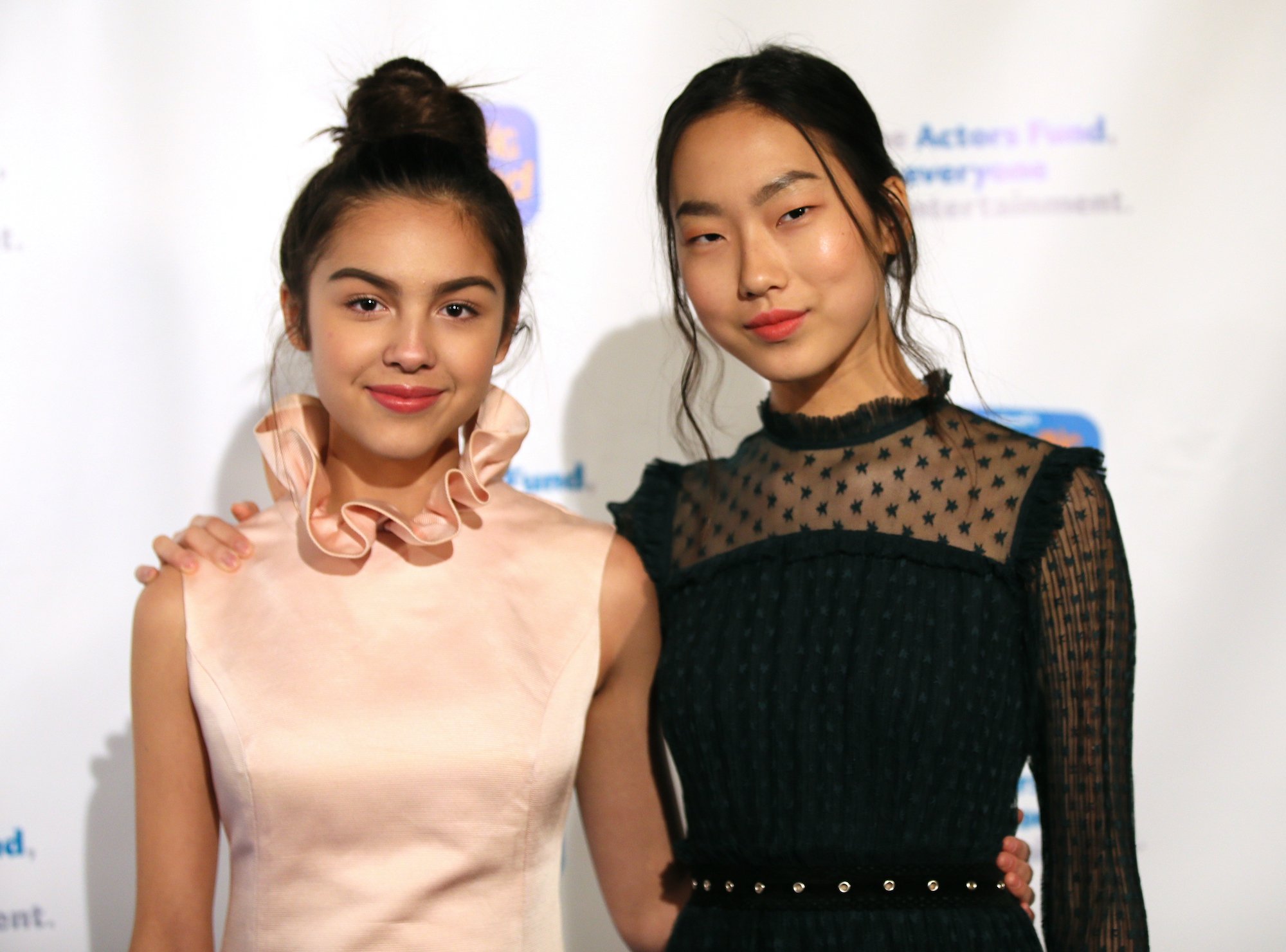 Olivia Rodrigo and Madison Hu smiling in front of a white background