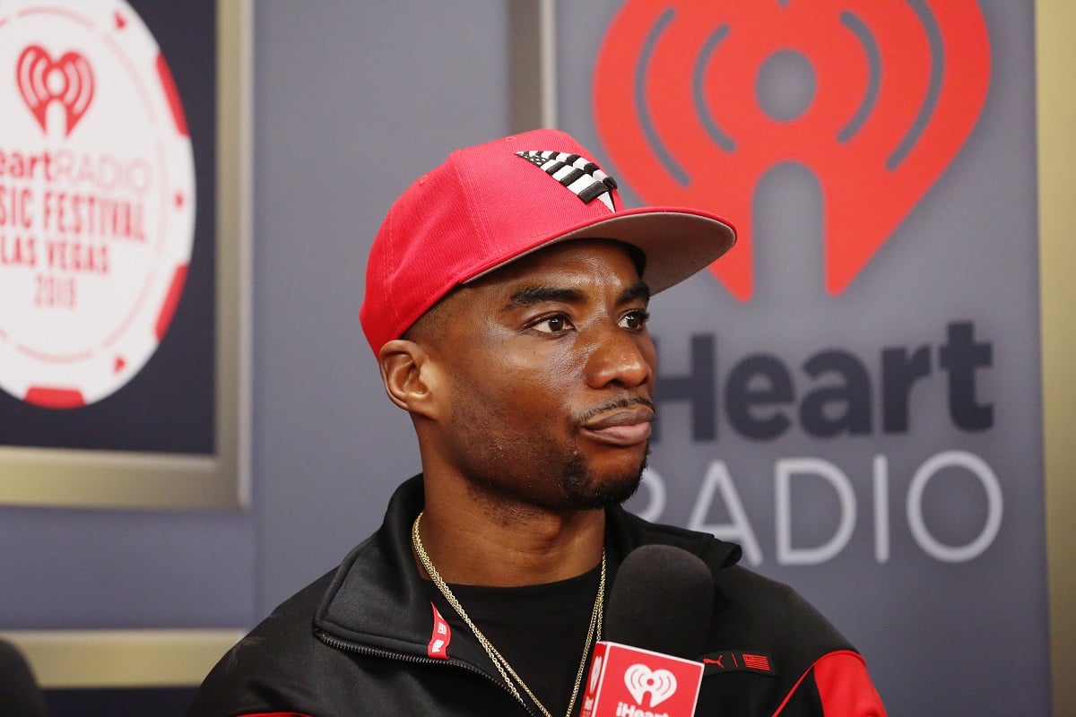 Photo of Charlamagne tha God from the shoulders up sporting a red cap at the iHeartRadio Music Festival 