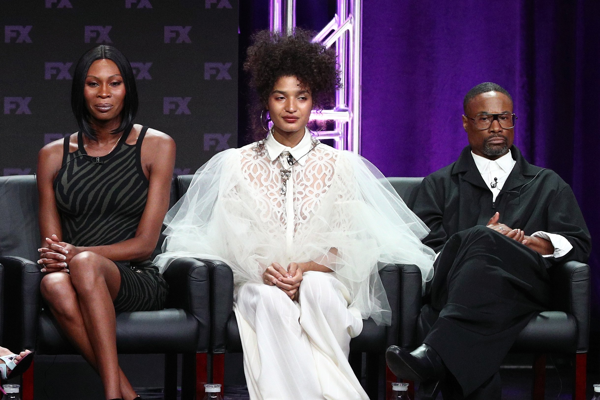 Actors Dominique Jackson in a black outfit, Indya Moore in white, and Billy Porter in a suit speak on stage at the 'Pose' panel