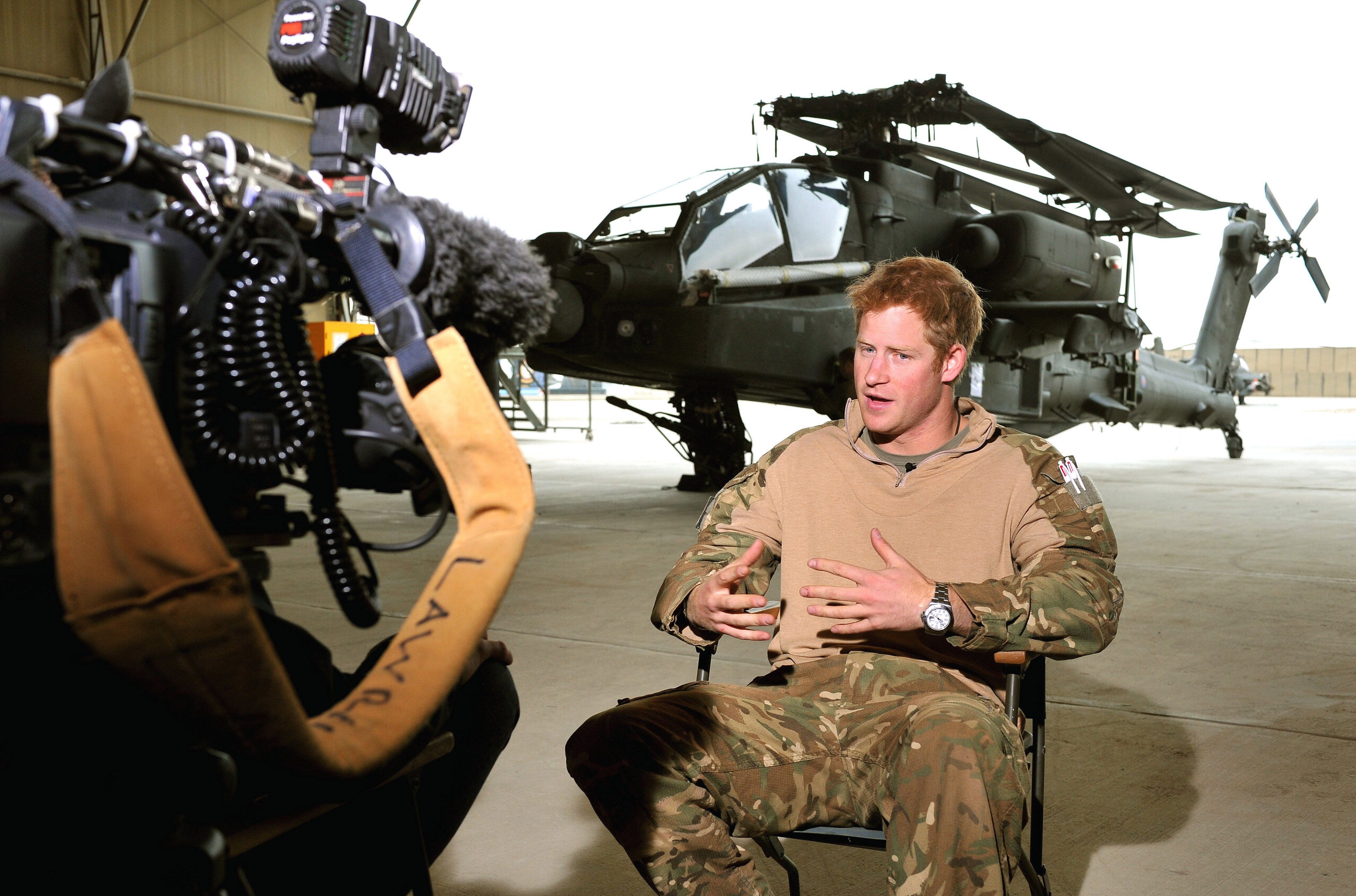 Prince Harry giving a TV interview in an Apache repair hanger on the flight-line at Camp Bastion