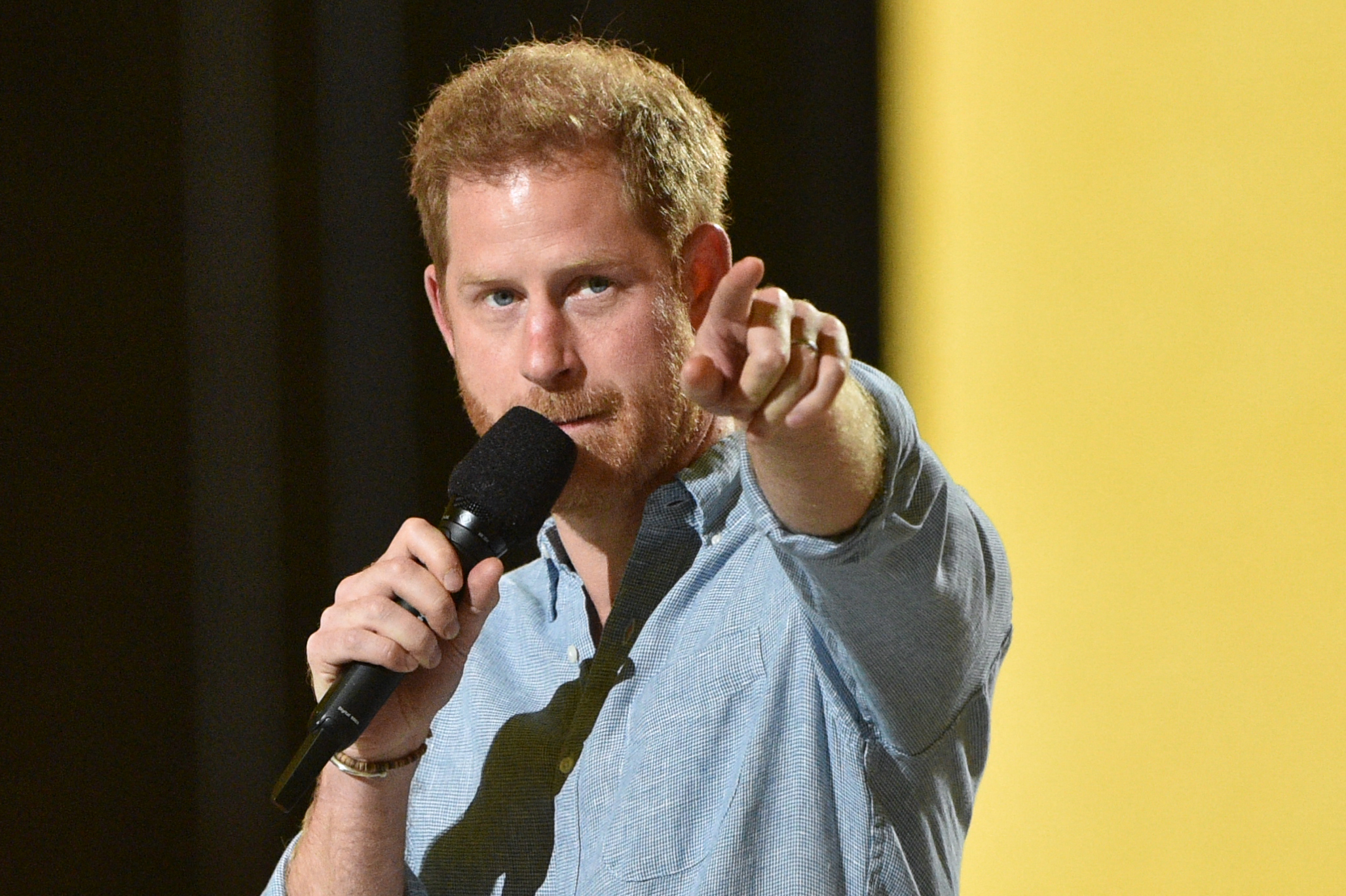Prince Harry points his left finger