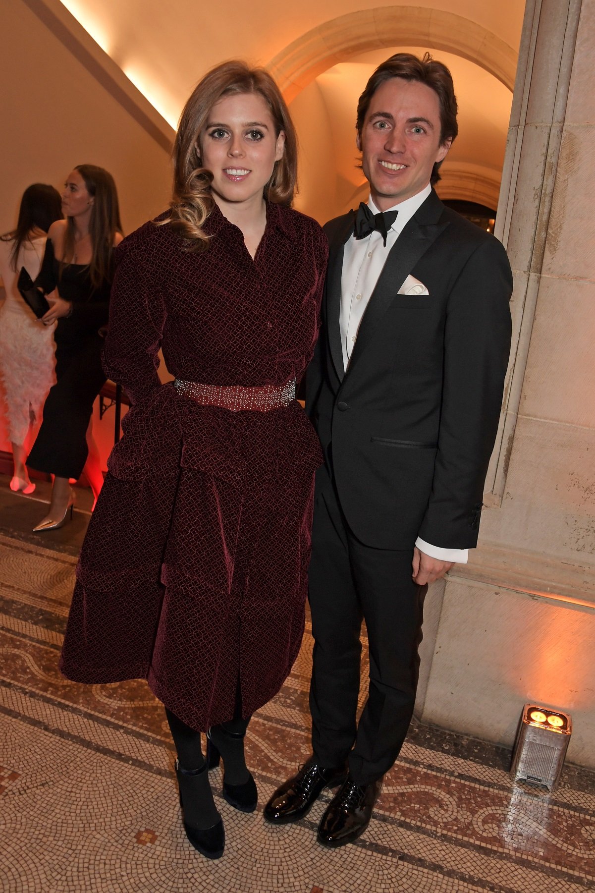 Princess Beatrice in a burgundy dress and Edoardo Mapelli Mozzi in a tuxedo pose for a photo at The Portrait Gala
