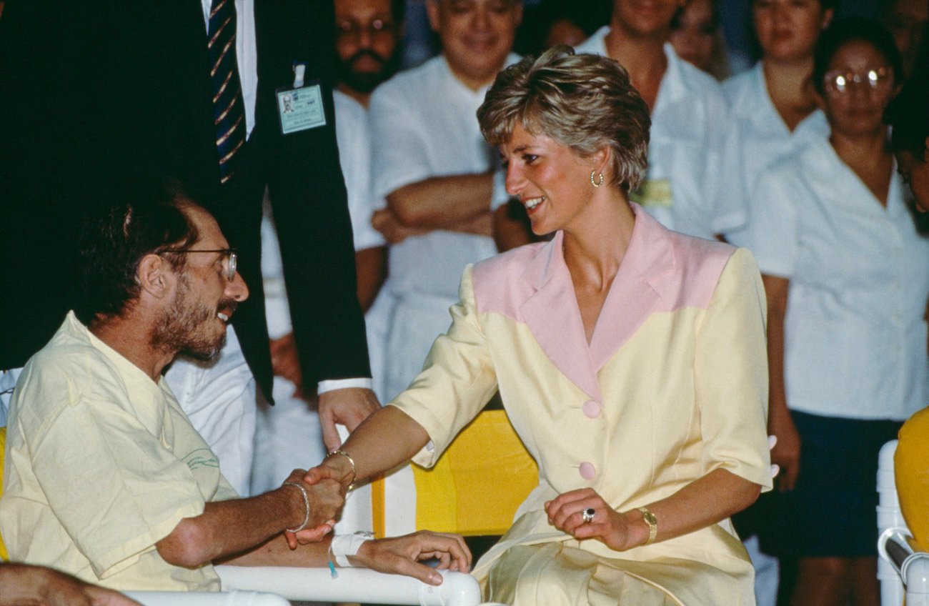 Princess Diana shaking hand with an AIDS patient