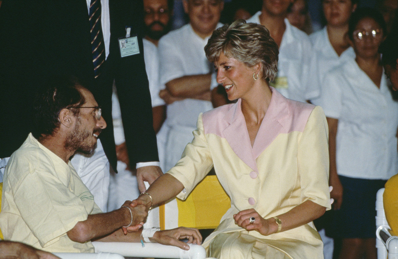 Princess Diana shaking hand with an AIDS patient