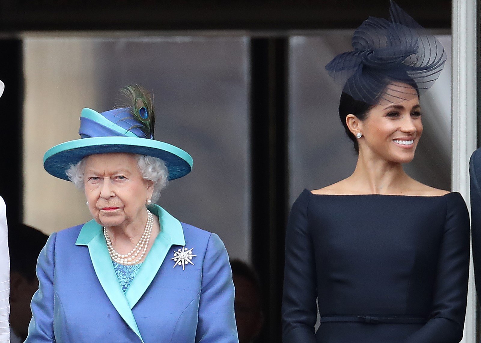 Queen Elizabeth II and Meghan Markle standing on the balcony of Buckingham Palace