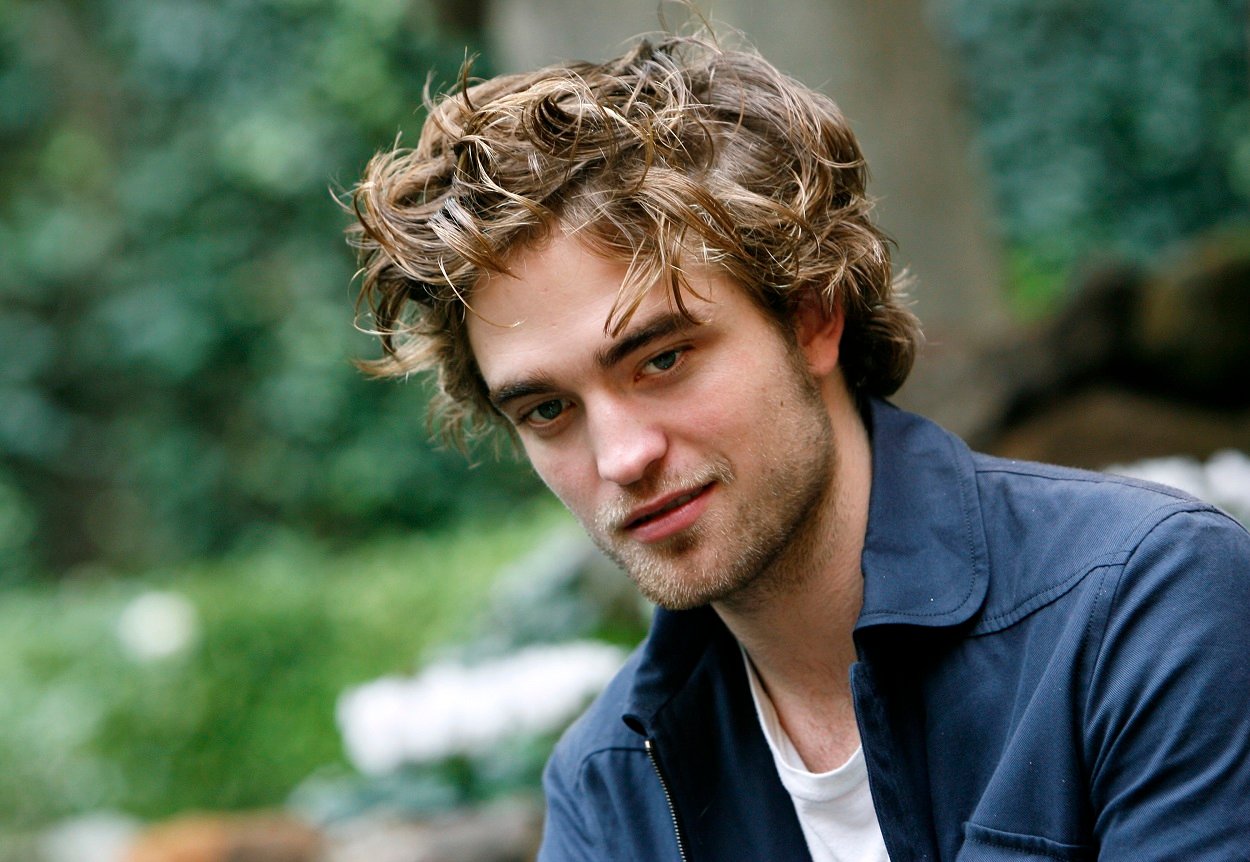 Twilight movies star Robert Pattinson poses for cast photos in a blue jacket