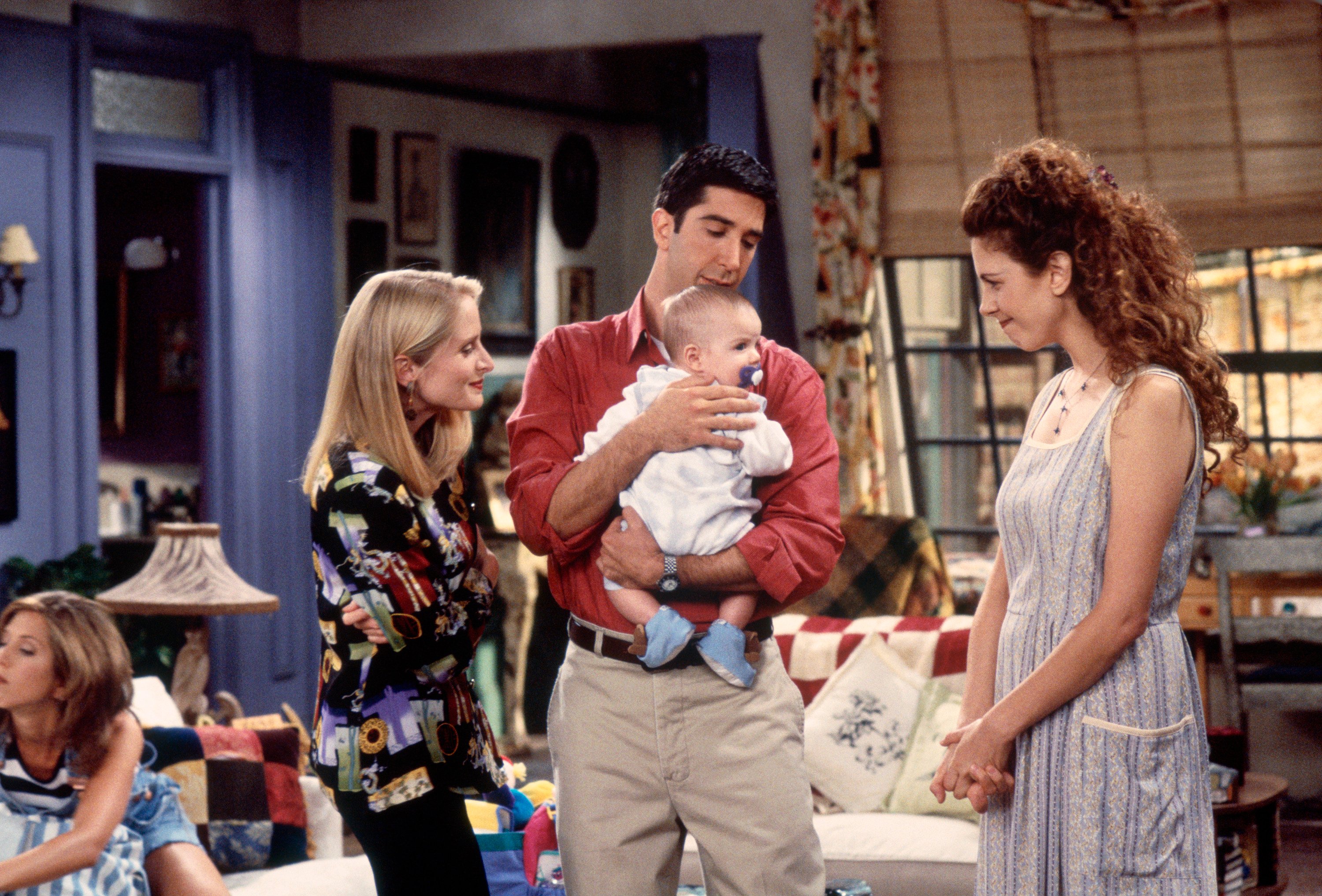 Ross holds his son with his ex-wife Carol, and Susan