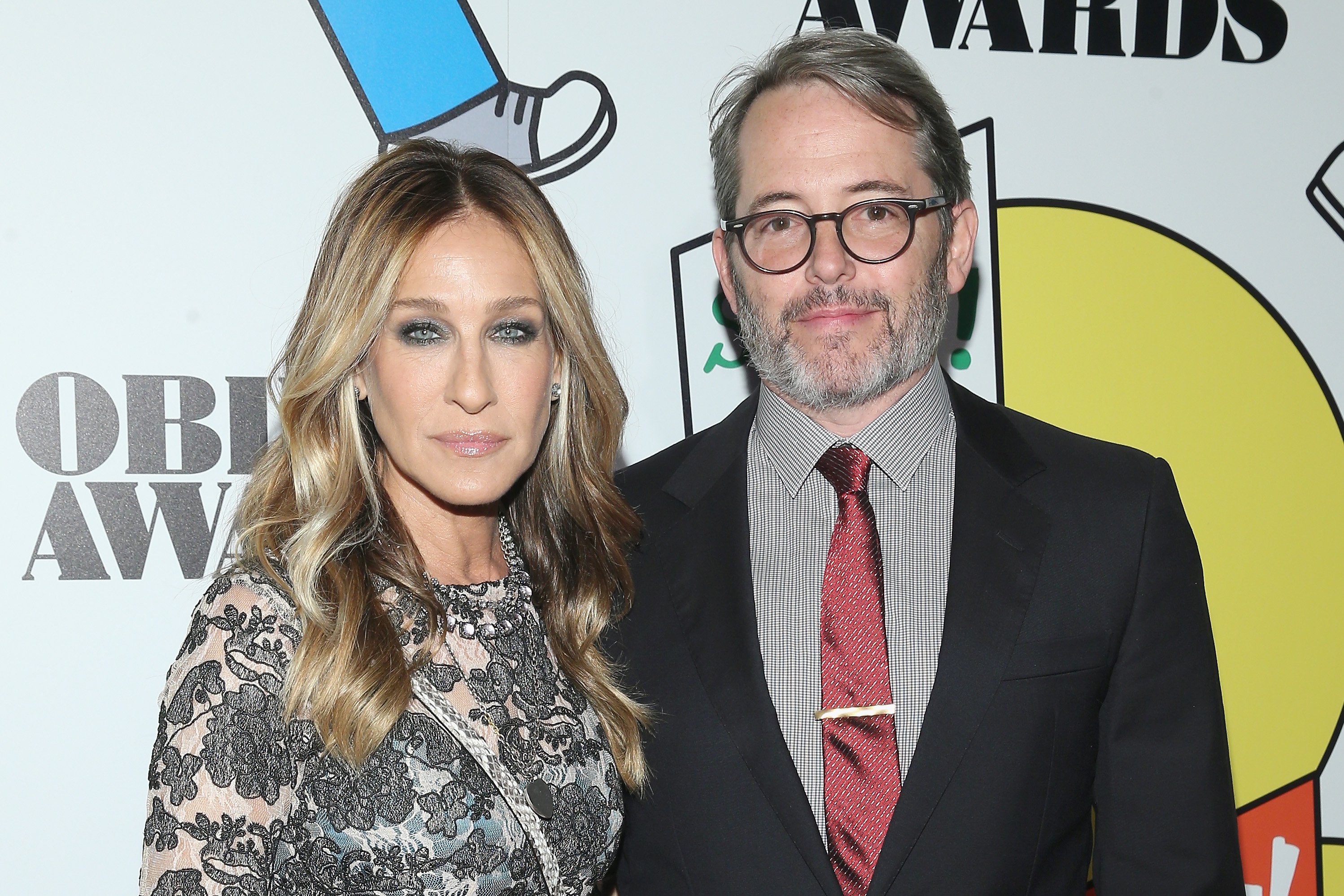 Sarah Jessica Parker and Matthew Broderick posing together while attending a red carpet event.