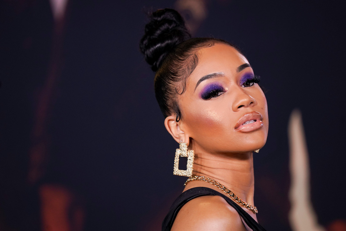 Saweetie wears purple eyeshadow and a high bun