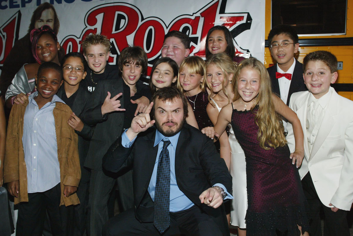 School of Rock cast pose in front of a school bus