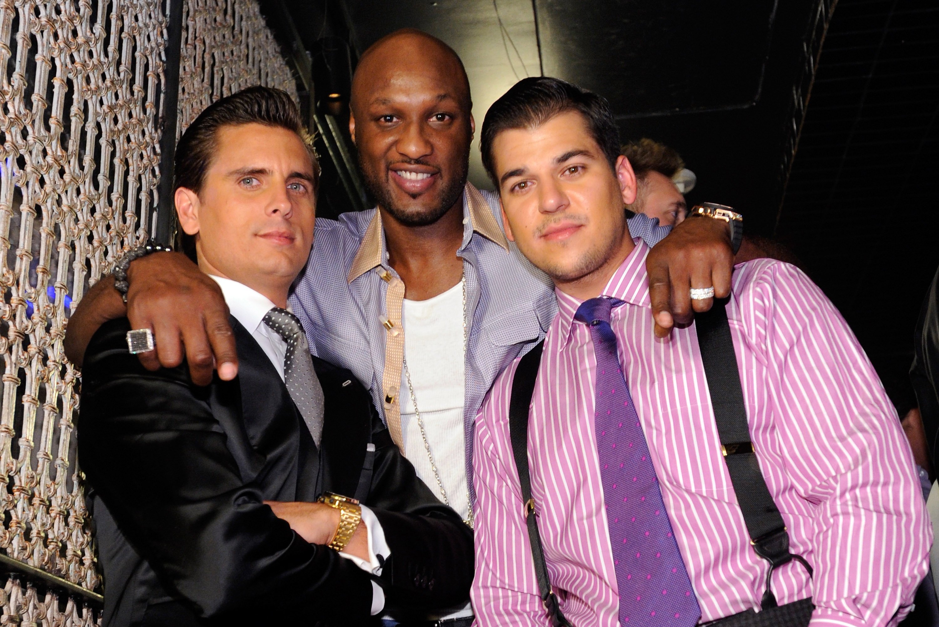 Lamar Odom puts his arms around Scott Disick and Rob Kardashian as they pose together at Kris Humphries' bachelor party.