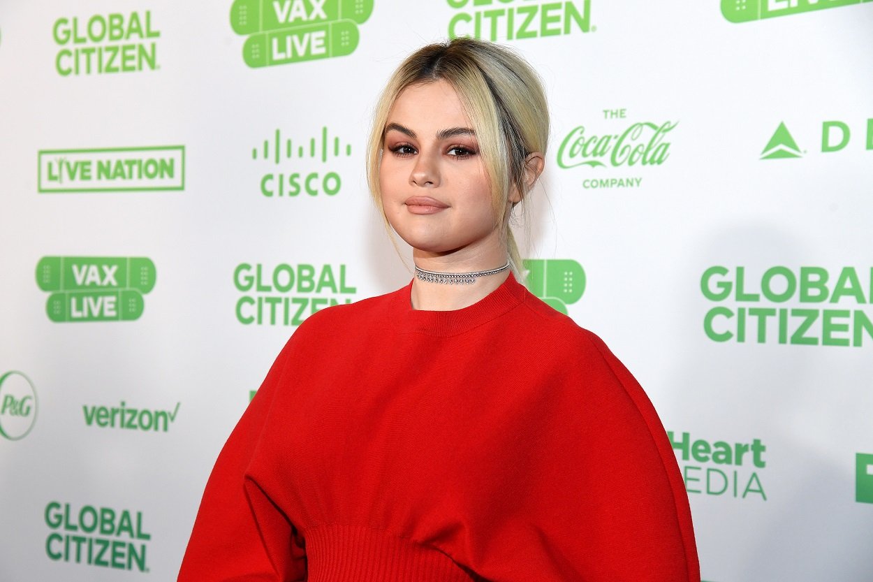 Selena Gomez in a red outfit and silver choker rocks new blonde locks