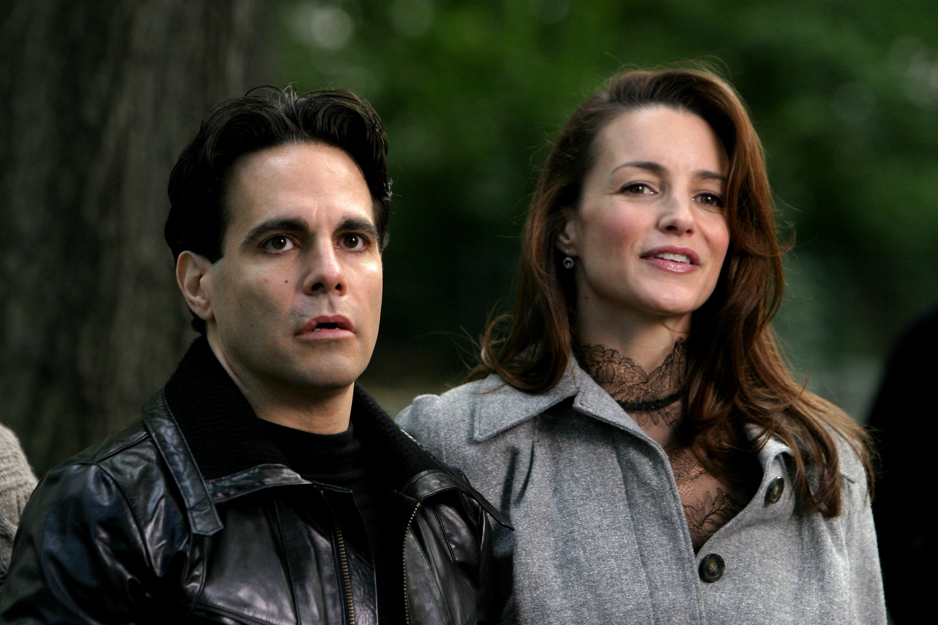Mario Cantone and Kristin Davis sit in Central Park during a scene for 'Sex and the City'
