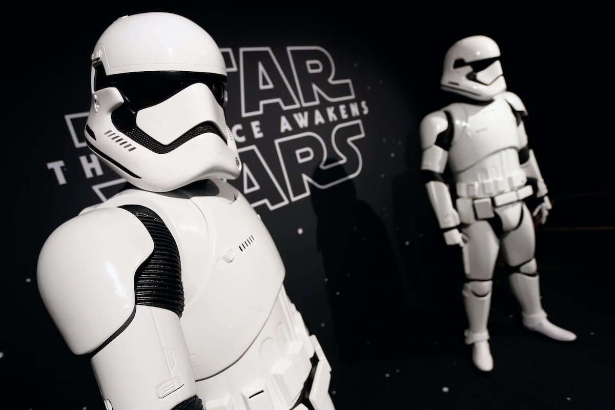 Two stormtroopers stand in front of the 'Star Wars: The Force Awakens' logo at the Star Wars 'Force 4 Fashion' event