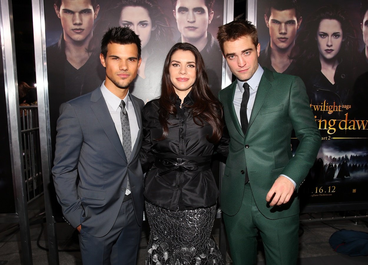 Taylor Lautner, Twilight author Stephenie Meyer, and Robert Pattinson pose for a picture at the premiere for the last movie in The Twilight Saga