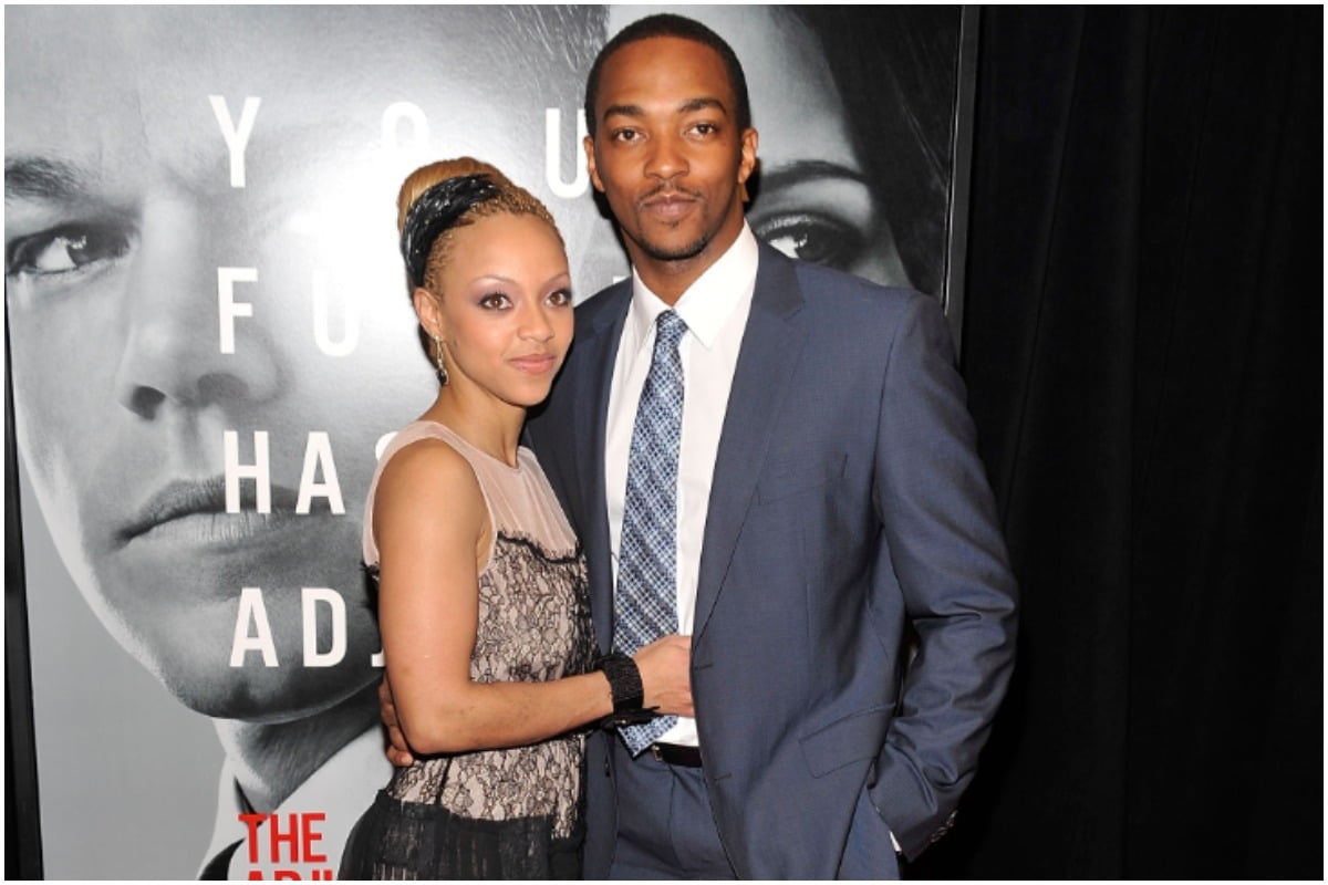 'The Falcon and the Winter Soldier' star Anthony Mackie wearing a blue suit and tie while embracing his ex-wife, Sheletta Capital. Capital is smiling while wearing a tan and black dress.